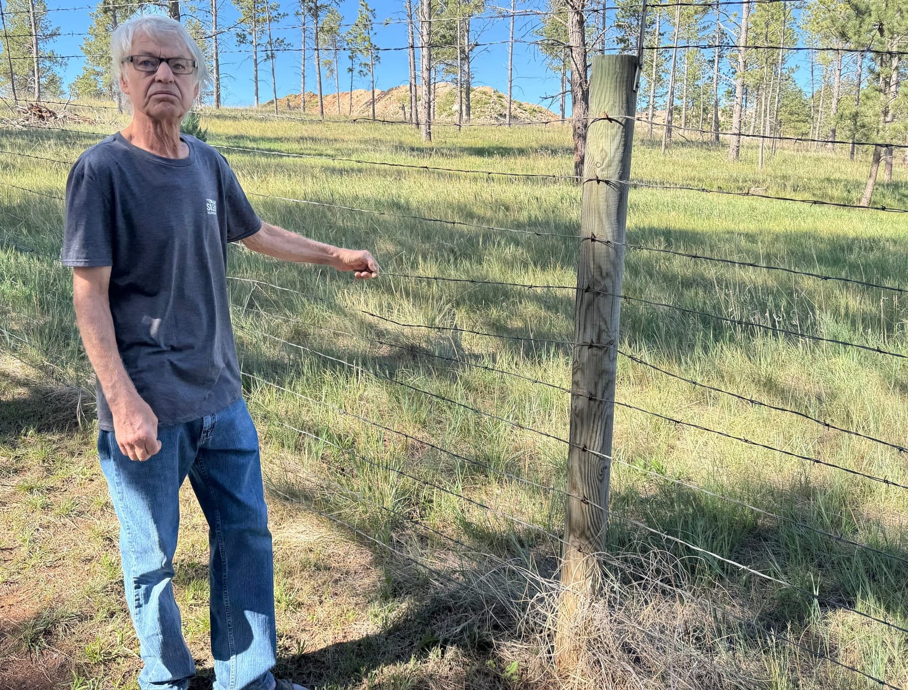 Black Hawk, S.D., resident Darrell Koepp on Sept. 3, 2026, at his fence line about 100 yards from the edge of a limestone mine