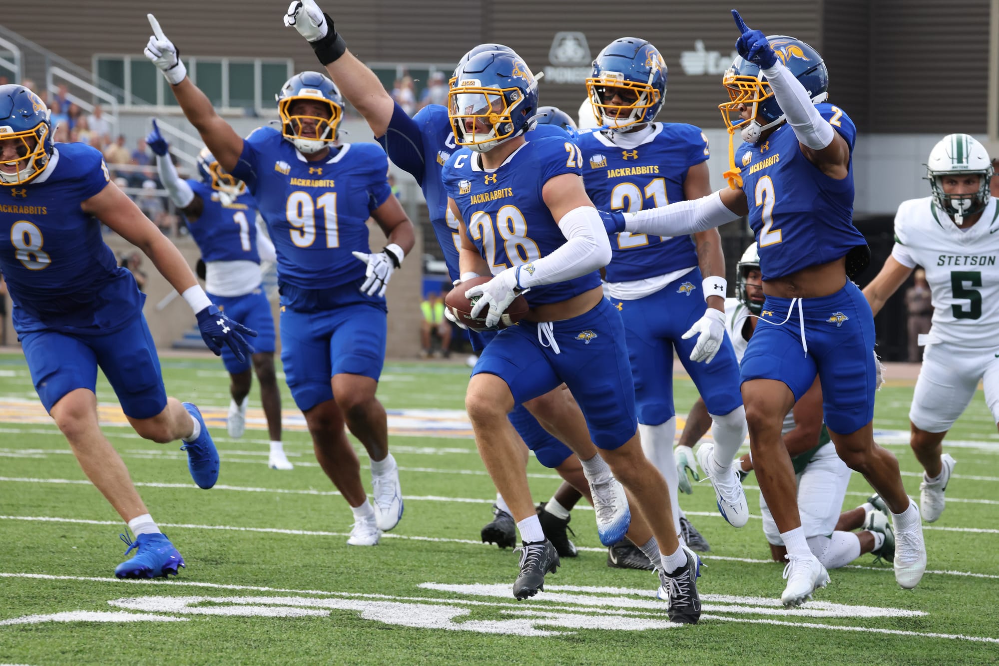 South Dakota State defensive players celebrate a fumble recovery