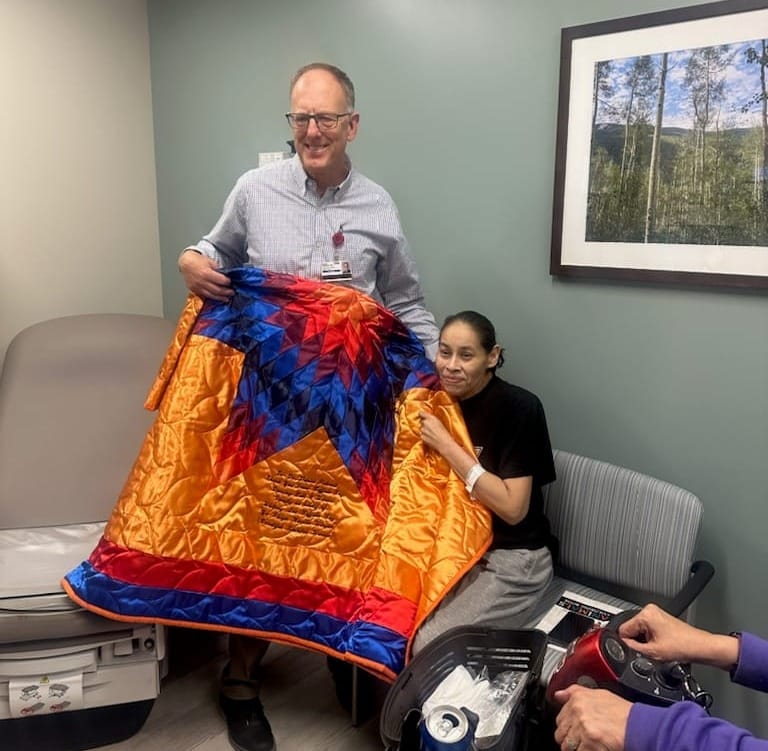 Petereit is presented with a Star Quilt with his name embroidered from Whitney