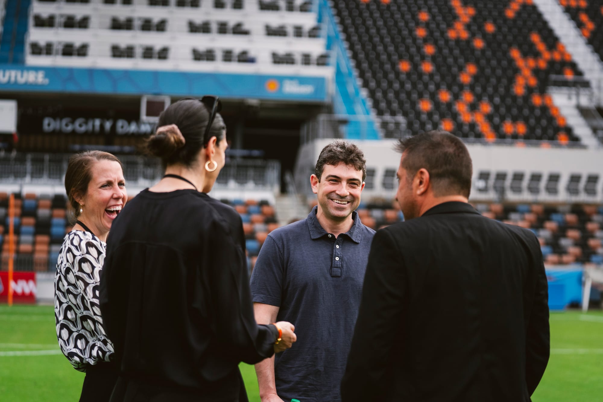 2024: Dash principal owner (second from right), Ted Segal, and club president of business operations, Jess O'Neill (left) talking to former general manager Alex Singer (second from left) and former head coach Fran Alonso (second from right) | Courtesy of Houston Dash