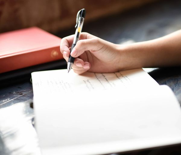 A closup of someone drafting their resume
