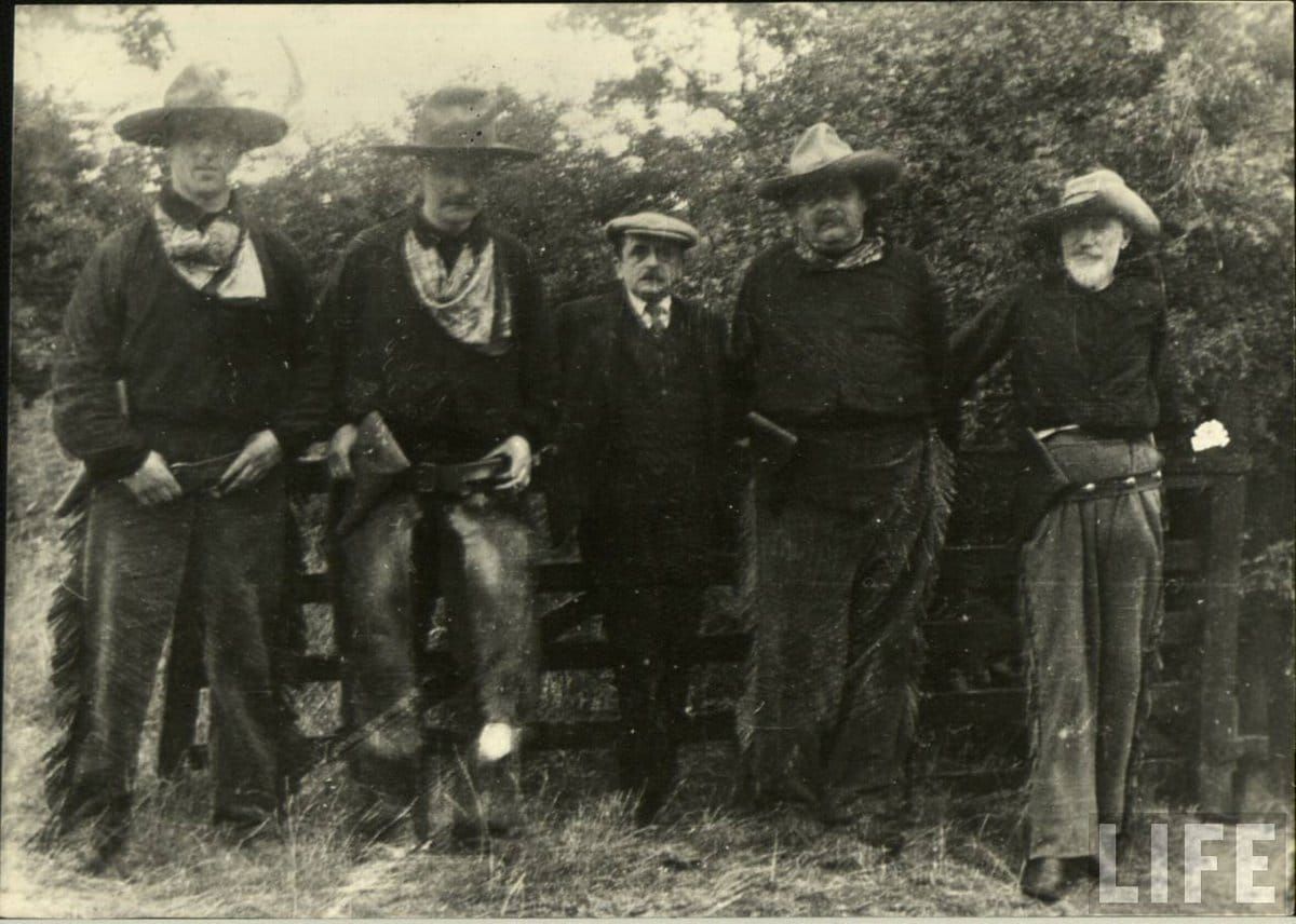 five unlikely actors in cowboy costumes on set of J.M. Barrie's western