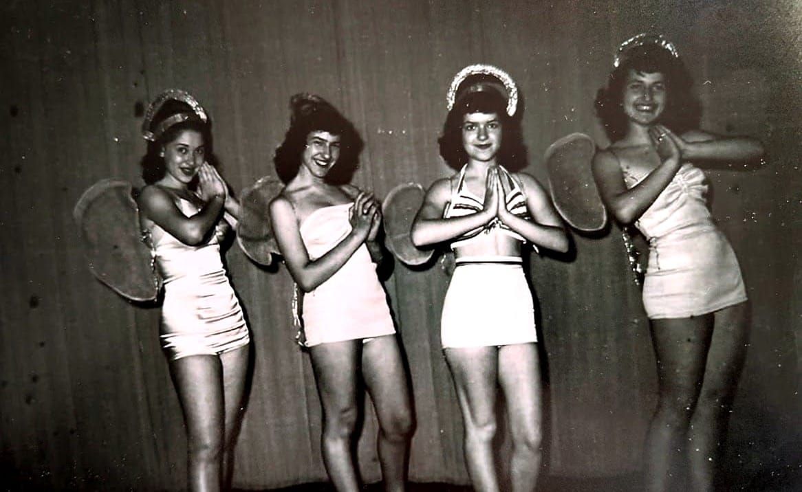 mymy mother with four other young women onstage decked out as angels in 1950s white bathing suits