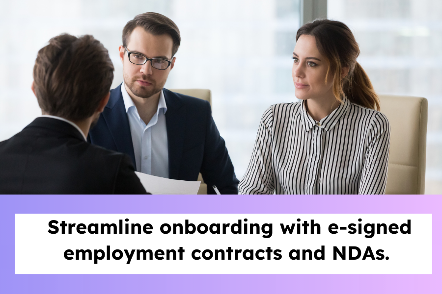 HR meeting with new employees signing documents.