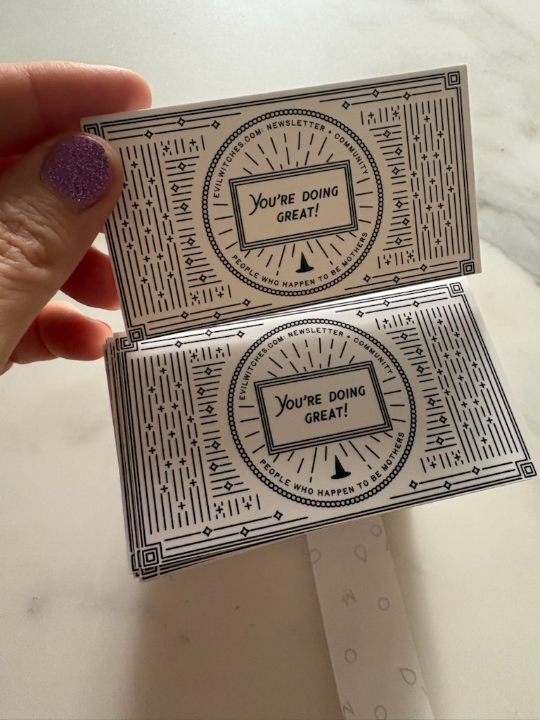 Evil Witches business cards that feature a pointy black hat and the note "You're doing great!" with a link to the site