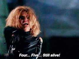 a woman in a black jacket is screaming and says " four five still alive "