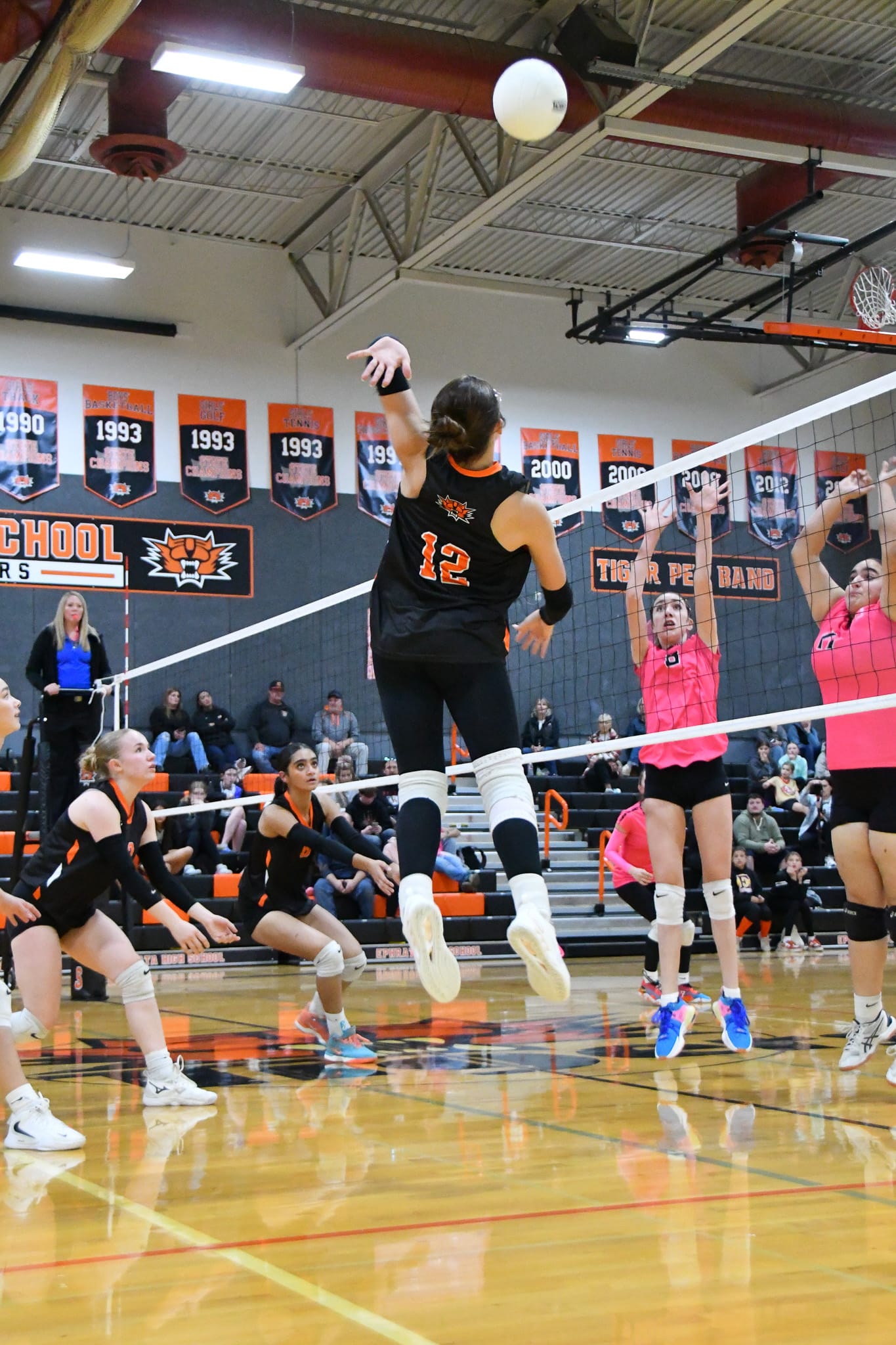 Ephrata’s Addison Vasquez (12) elevates for a kill, sending the ball past two Othello defenders.