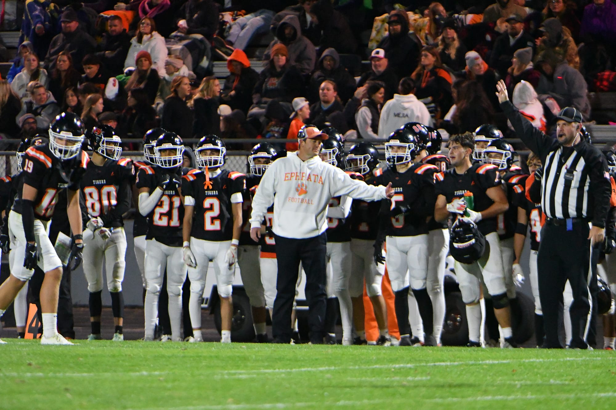 Head coach Patrick Mitchell signals to his players during first-half action of the homecoming game.