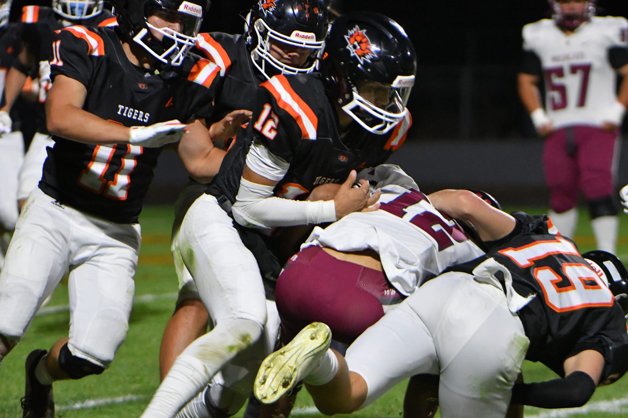 Quarterback Brady Hendrick (12) gets a push from Calvin Lybbert (11) and a block from Mitchell Morford (19) to pick up a few extra yards.