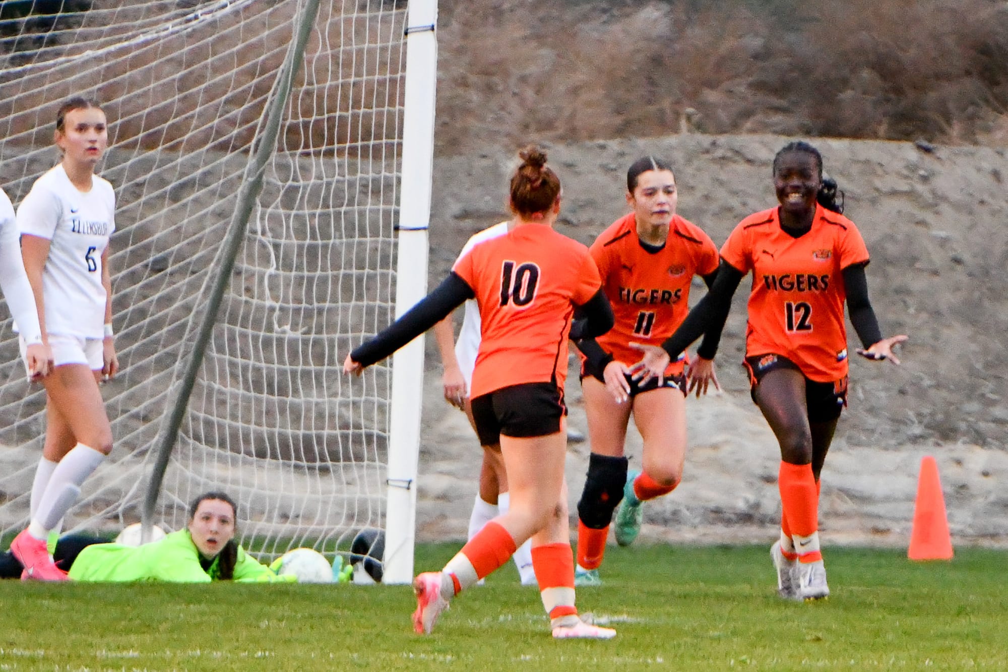Brooklynn Sieverkropp (10), Delanie Killinger (12) and Paige Murray (11) celebrate Ephrata's lone goal in the district match against Ellensburg.