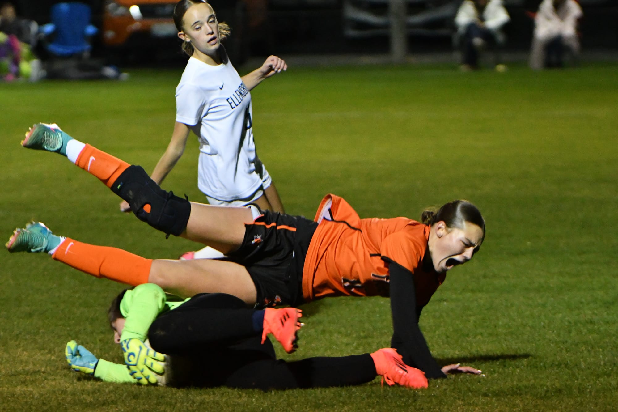 Ephrata sophomore Paige Murray (11) falls after contact with the Ellensburg goalkeeper in the second half of the Tigers' 4-1 loss. Murray left the match with an unspecified injury and did not return.