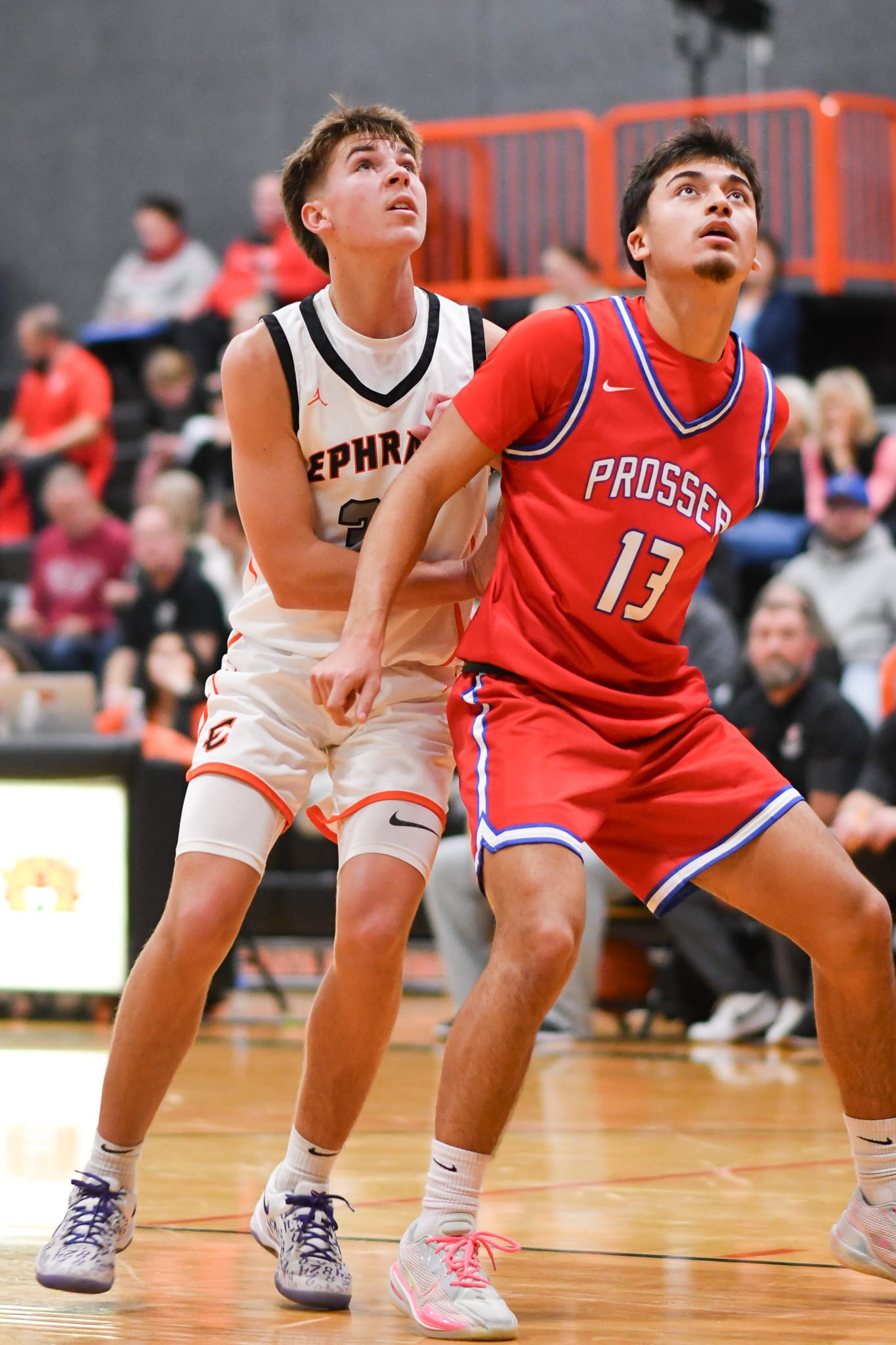 Ephrata's Caiden Weber (32) fights Noah Medrano (13) of Prosser for rebounding position.