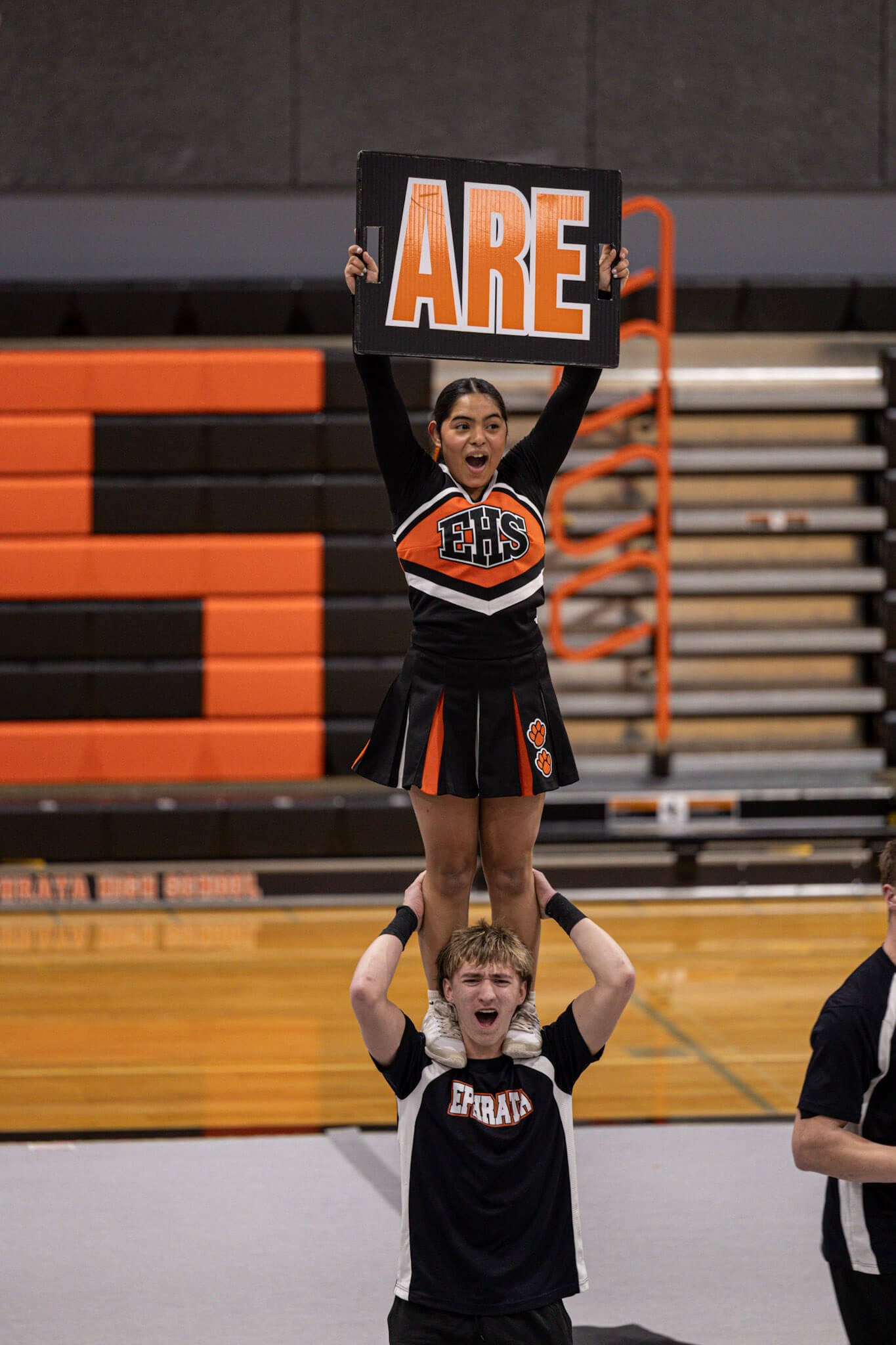 Ephrata's Kimberly Ortiz stands atop the shoulders of Charles Poirrier during the showcase.