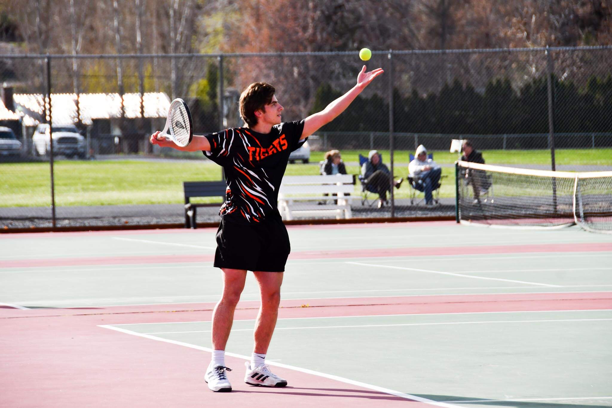 Gavin Somes winds up for a serve during Ephrata's home match against Ellensburg. Somes paired with Athen Gault at 1st doubles in both matches last week.