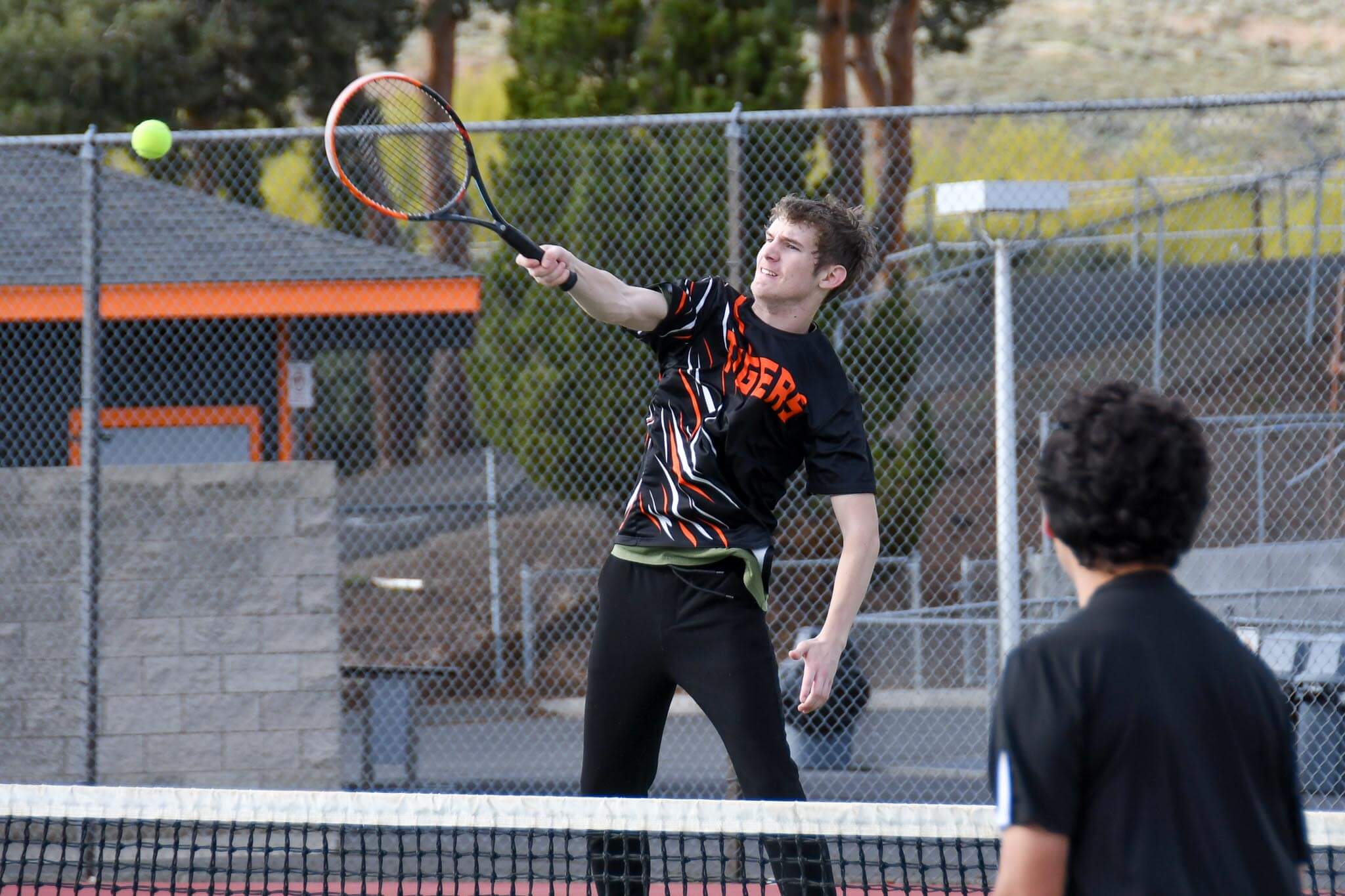 Ben McLain connects on a forehand during Ephrata's home match against Ellensburg.