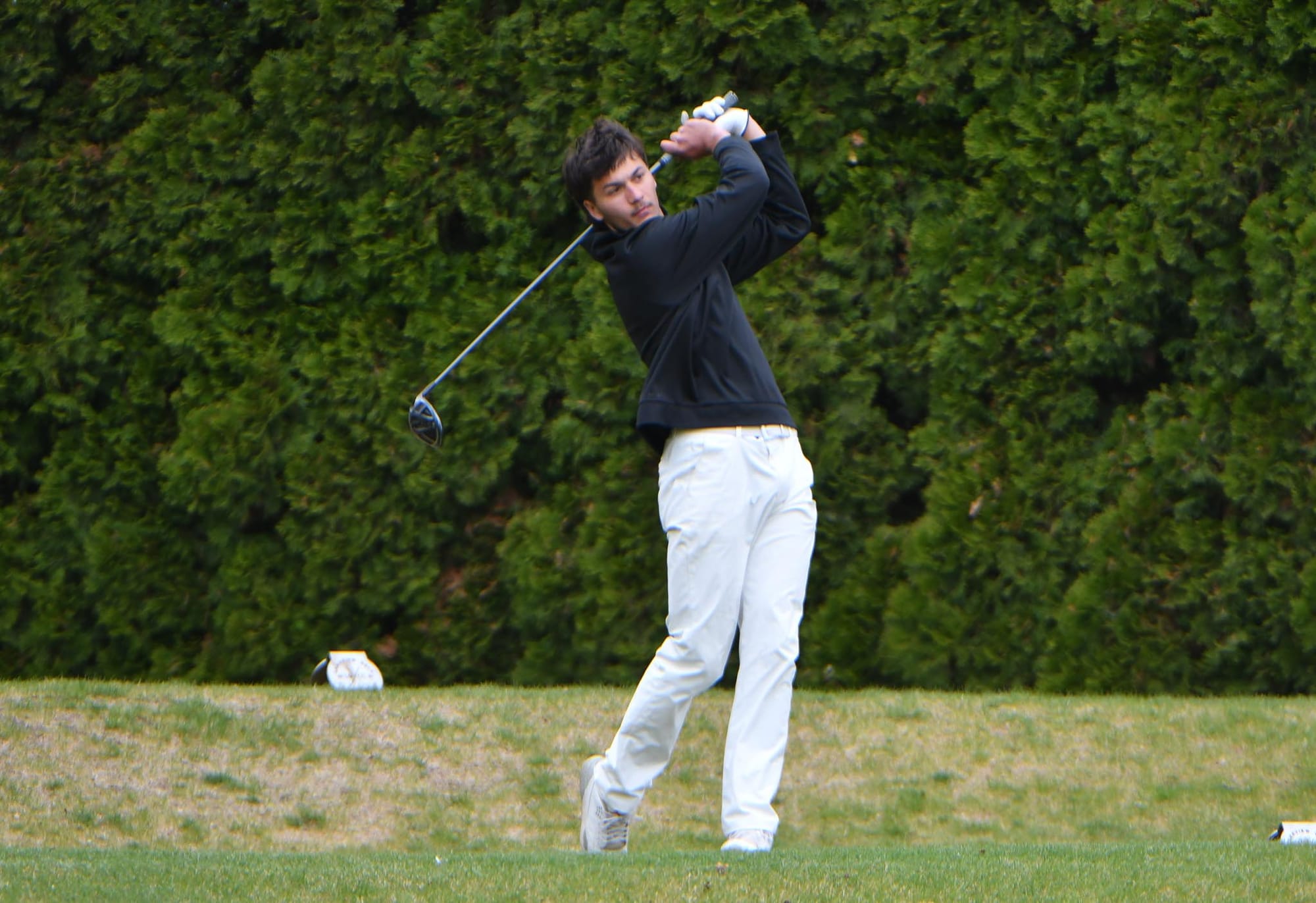 Brady Hendrick drives off the tee on hole 9 during the senior night match