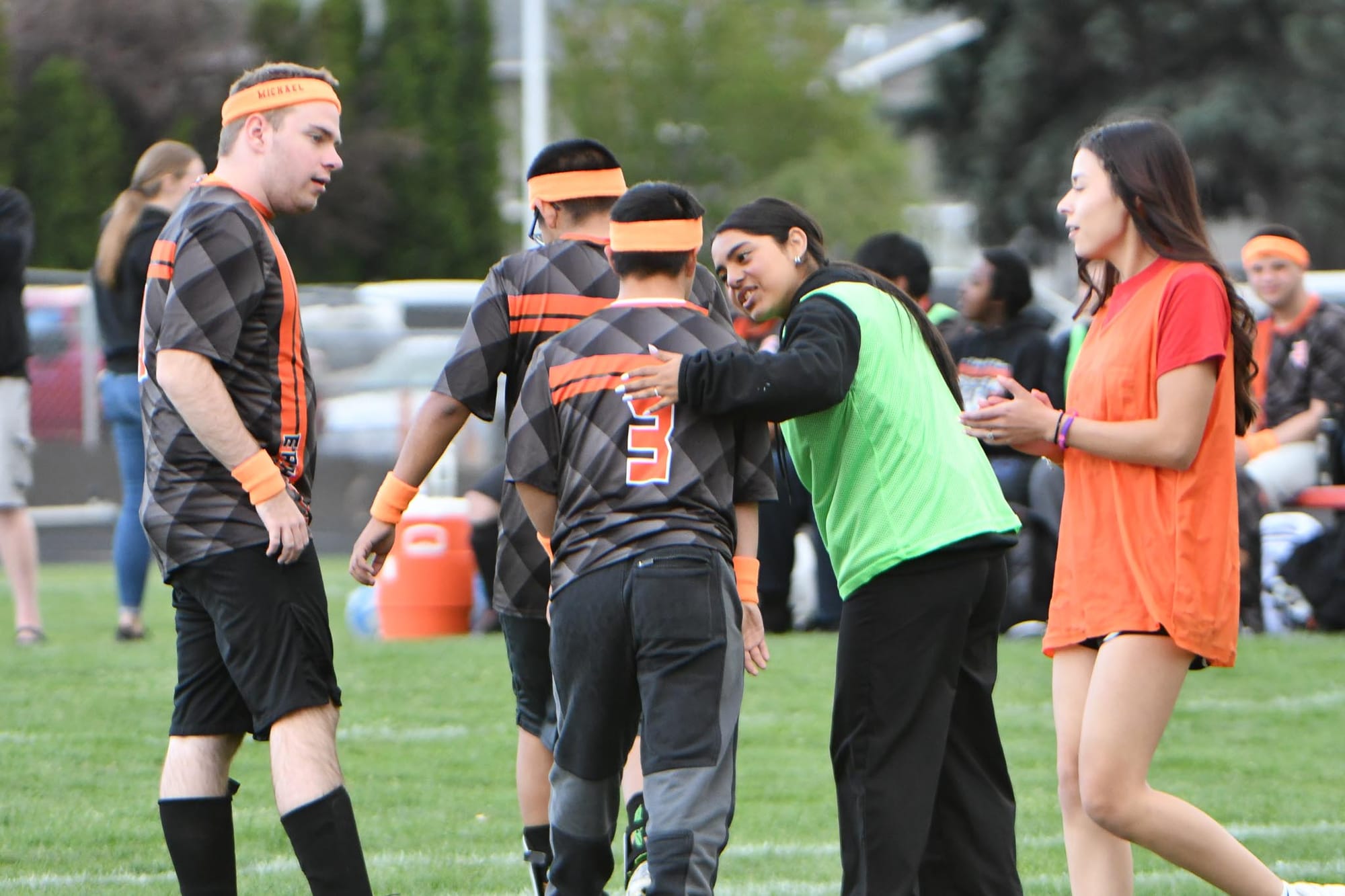 From left, Michael Borst and Alejandro Negrete Ramirez (3) walk up the field with helper Kimberly Ortiz during Thursday's game.