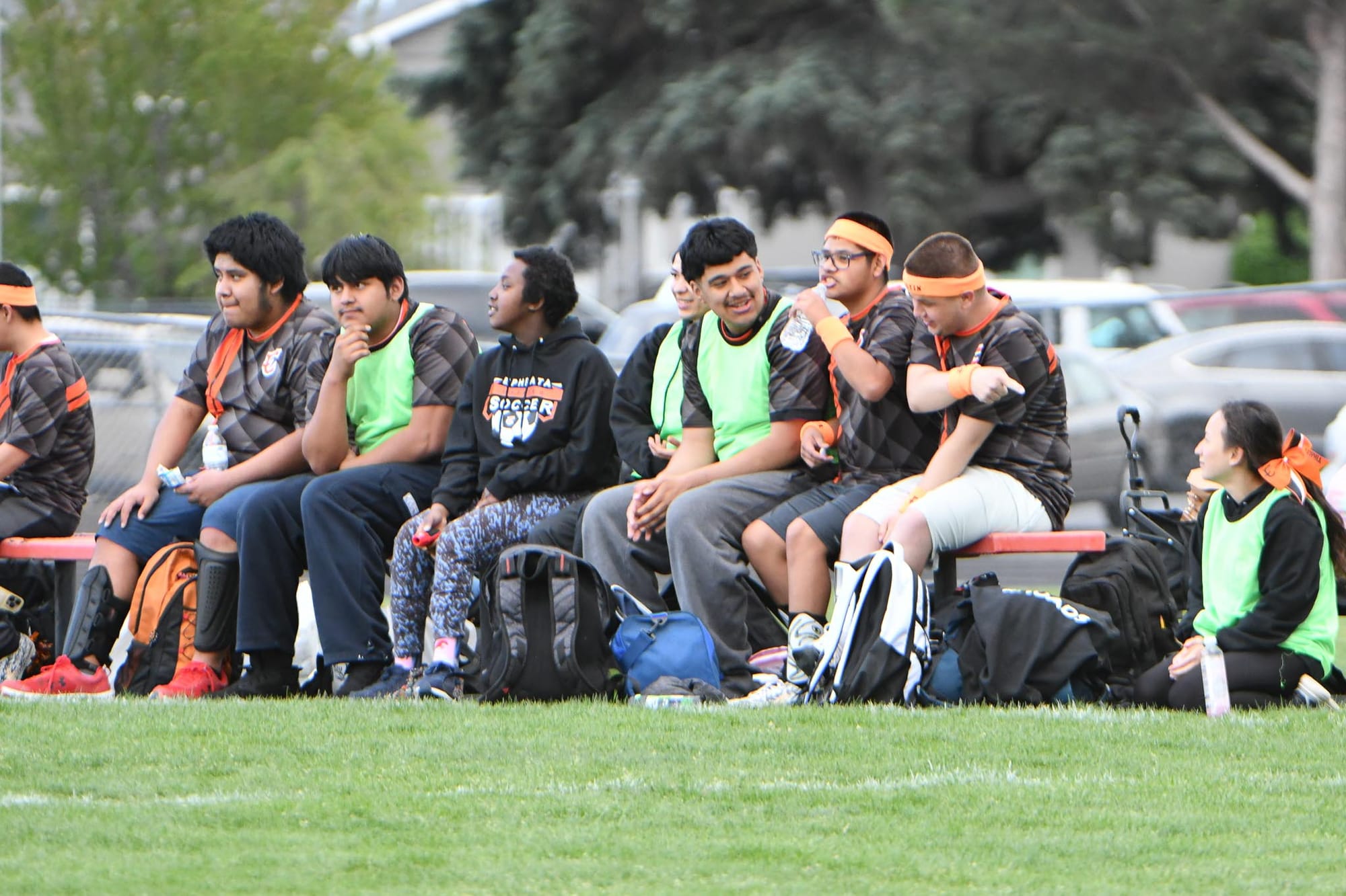 Tigers athletes and helpers share the bench.