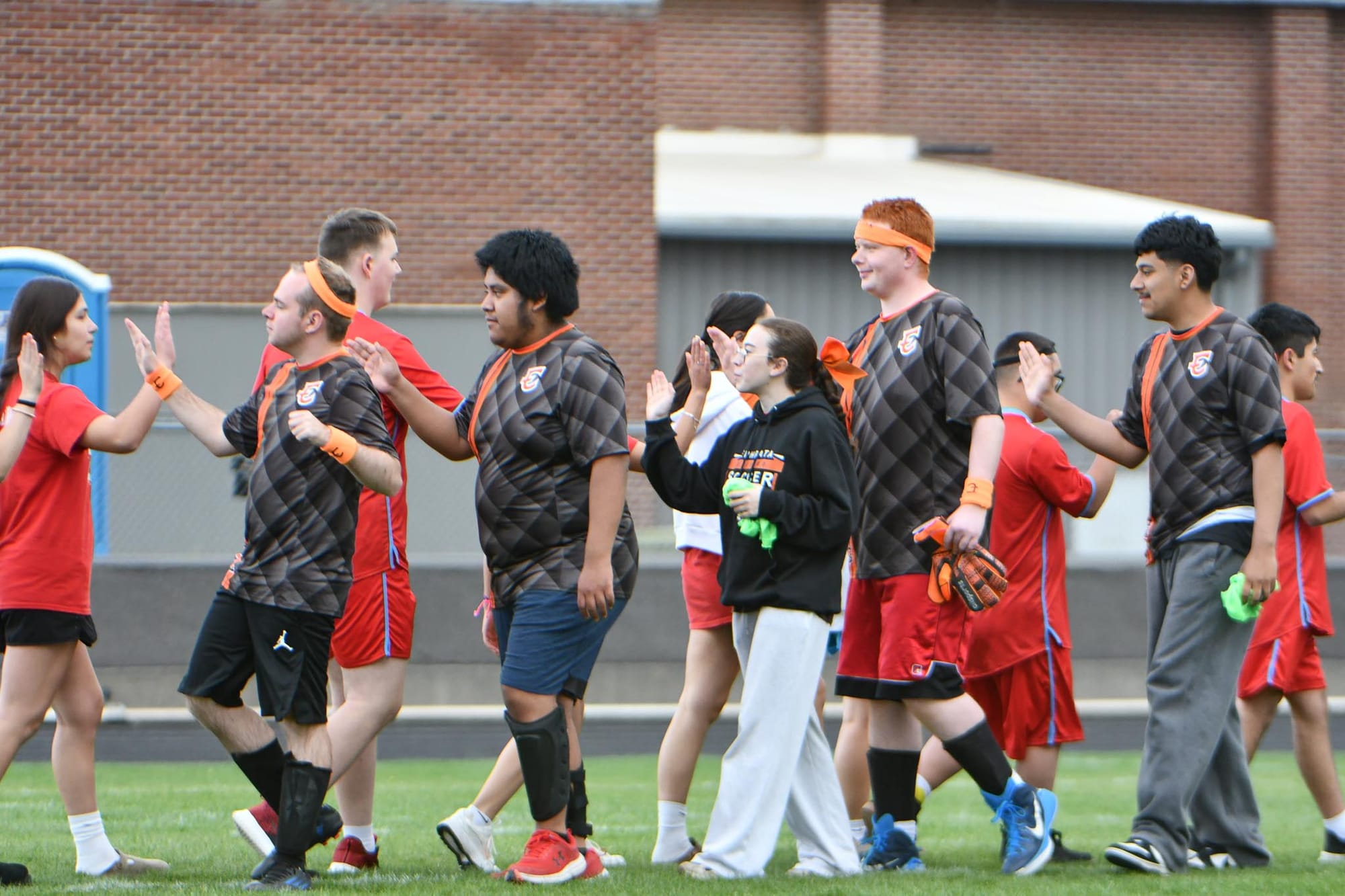 The Tigers and Wildcats close out their spirited Kiwanis Field matchup with high-fives. Photos by Casey Devine
