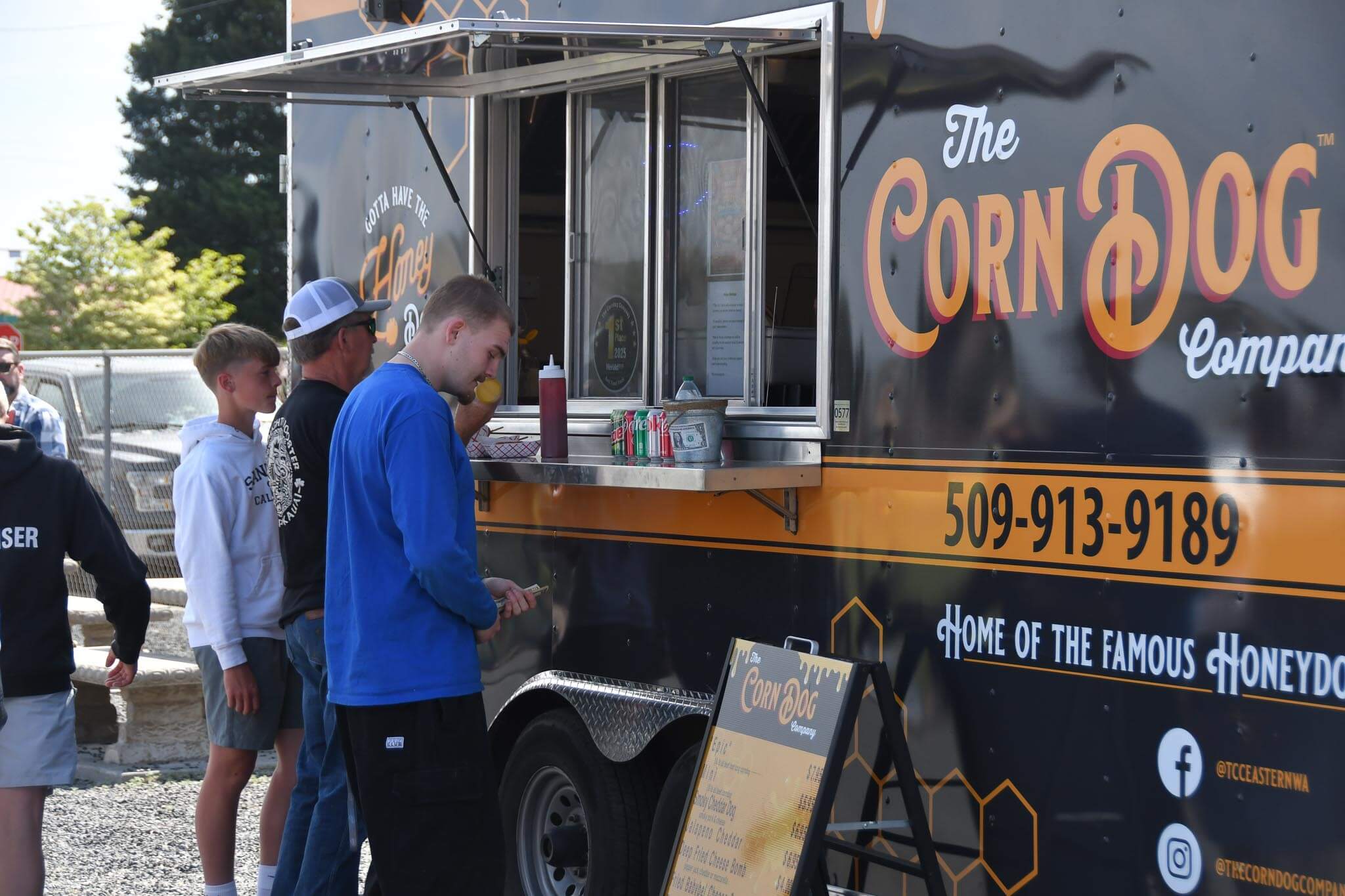 A line forms at the Corn Dog Company truck, one of several vendors on site.