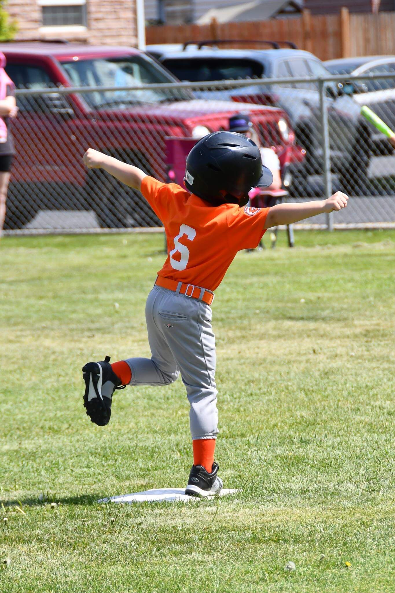 A runner celebrates with the crowd after reaching second.