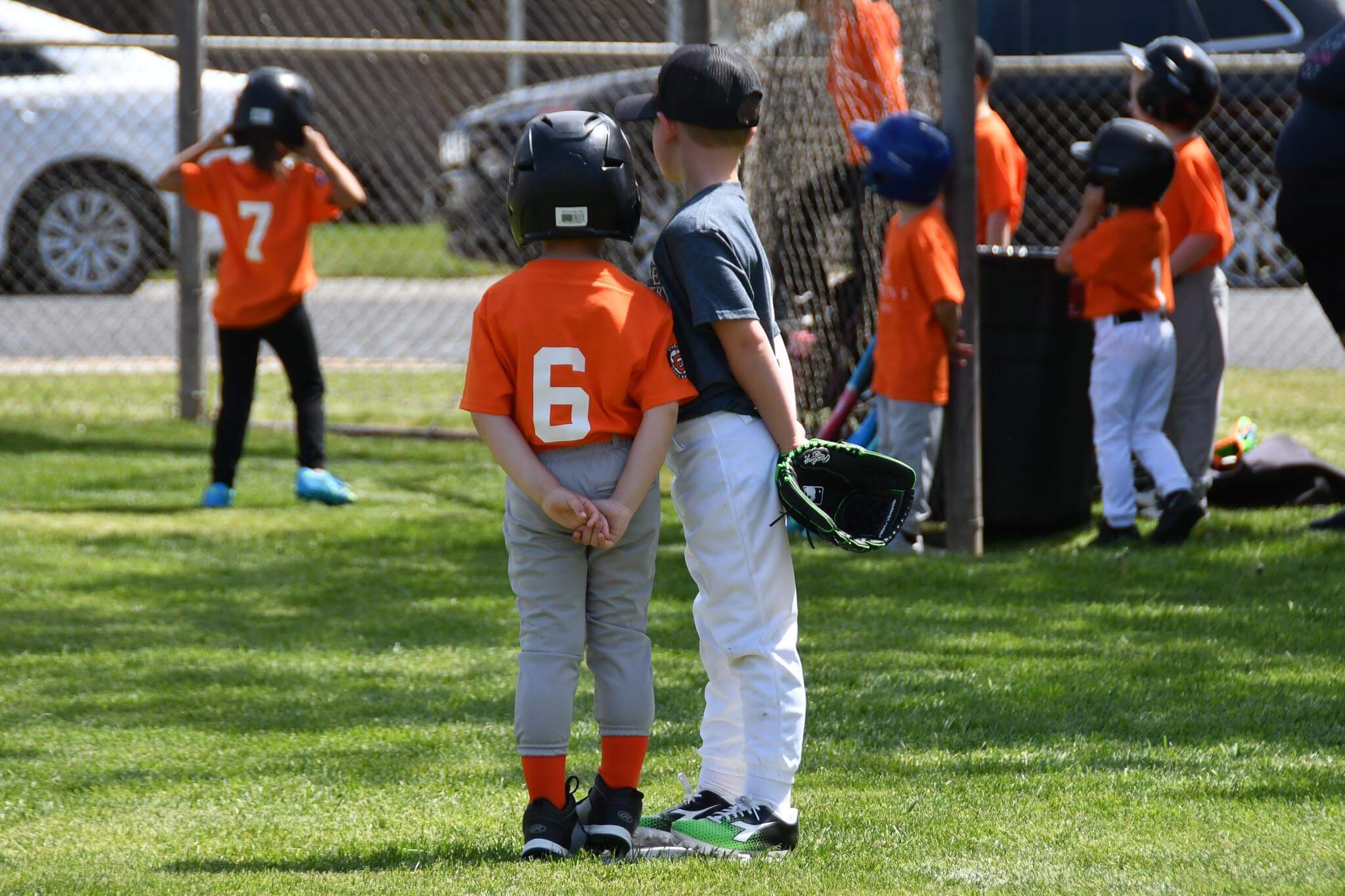 A runner and the third baseman share the bag as they wait for the next hit.