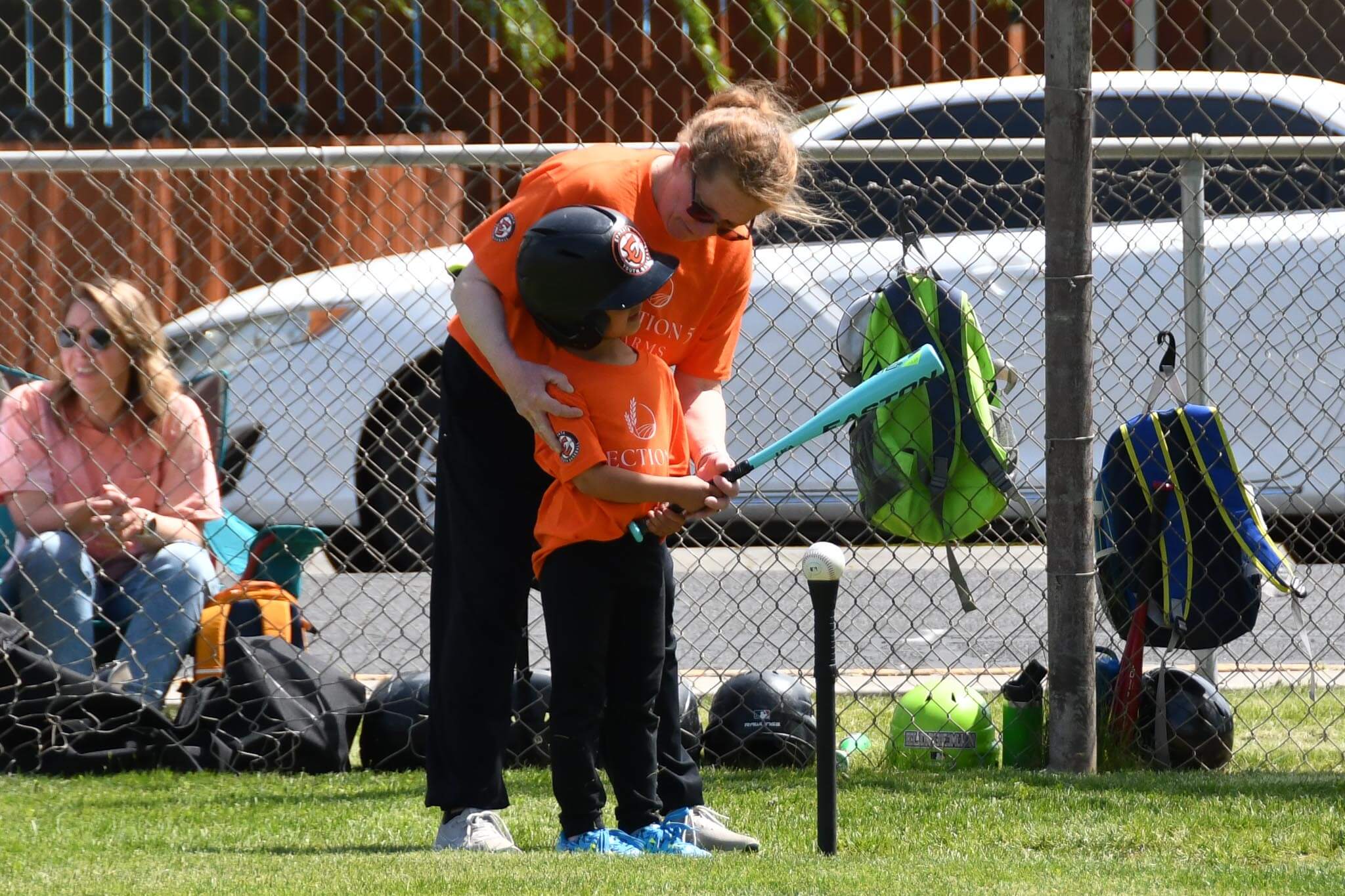 A T-ball coach offers some pointers at the plate.