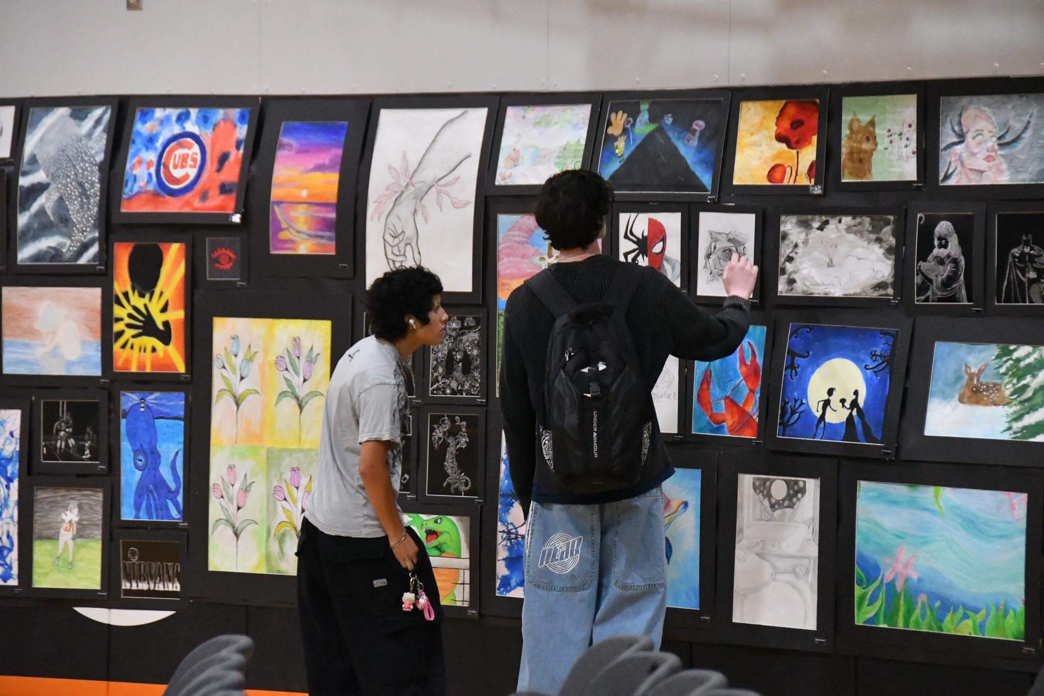EHS students walk through the school's art gallery Thursday as staff and student artists prep the space for next week's Multi-Arts Festival, which opens Monday, May 18.