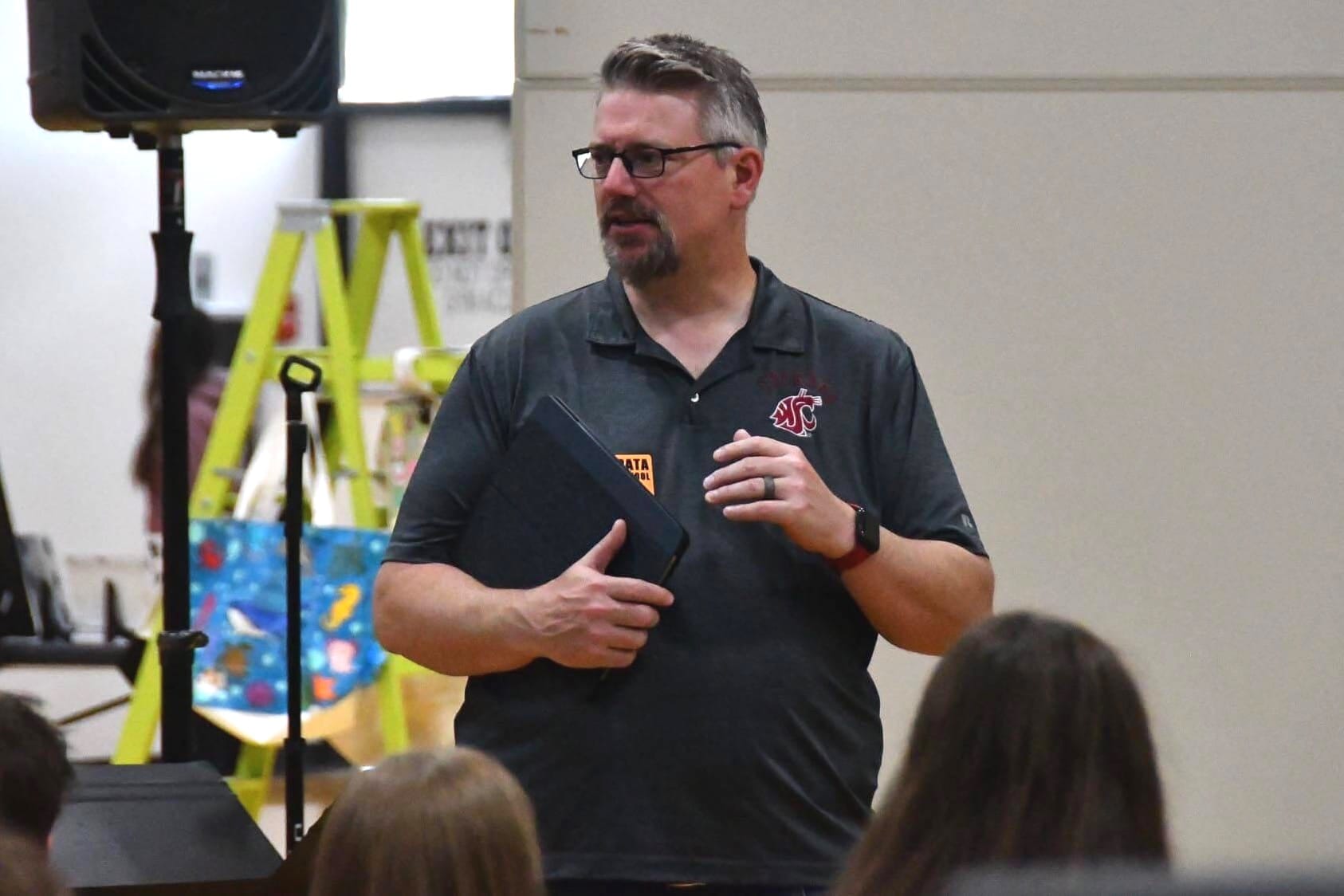 Dr. Dean Luethi, WSU's director of choral activities, speaks with EHS students between performances Thursday morning, encouraging them to keep singing past high school.