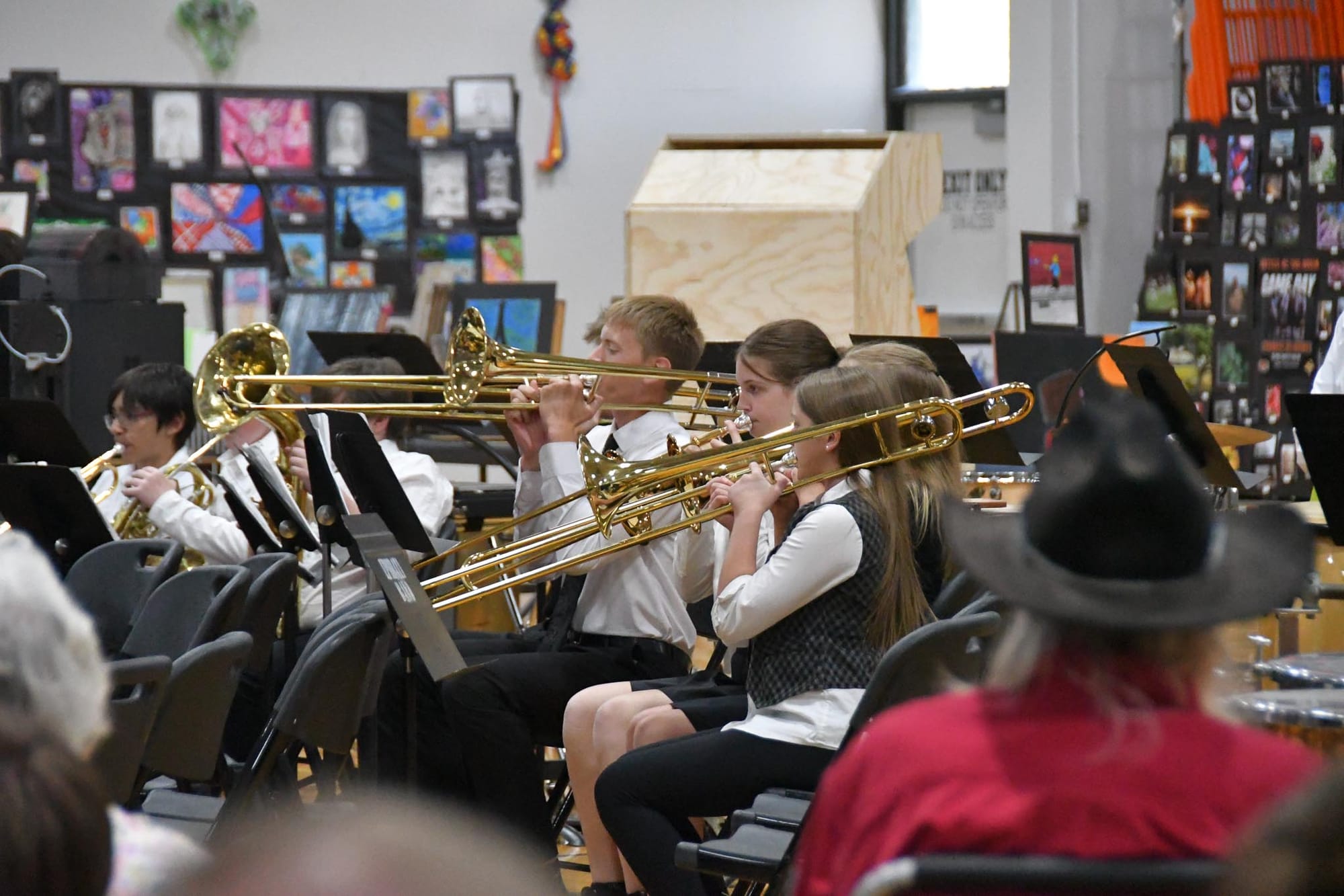 EHS trombone players perform during Tuesday's band concert as student artwork lines the gym walls behind them.