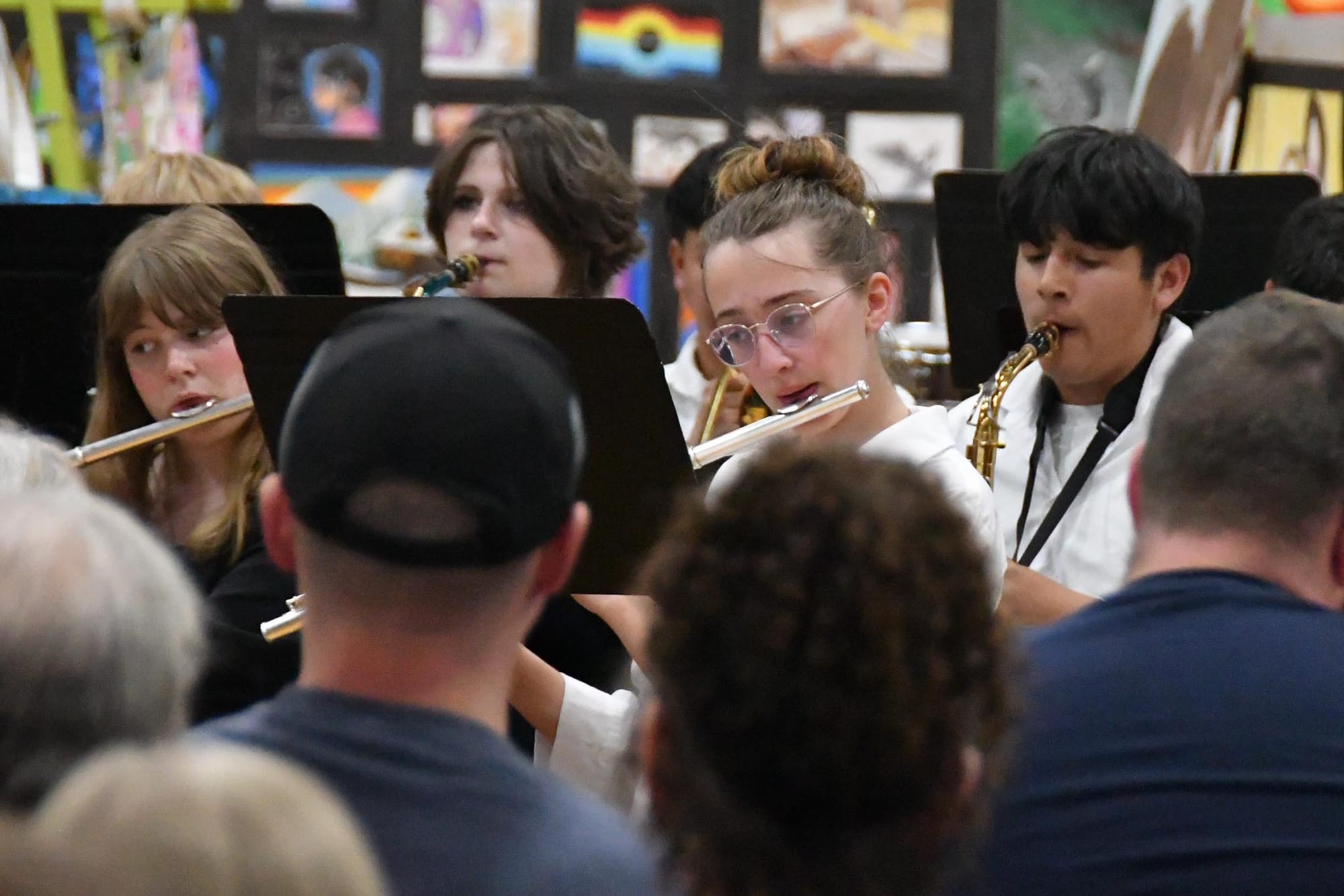 Flute and saxophone players perform.