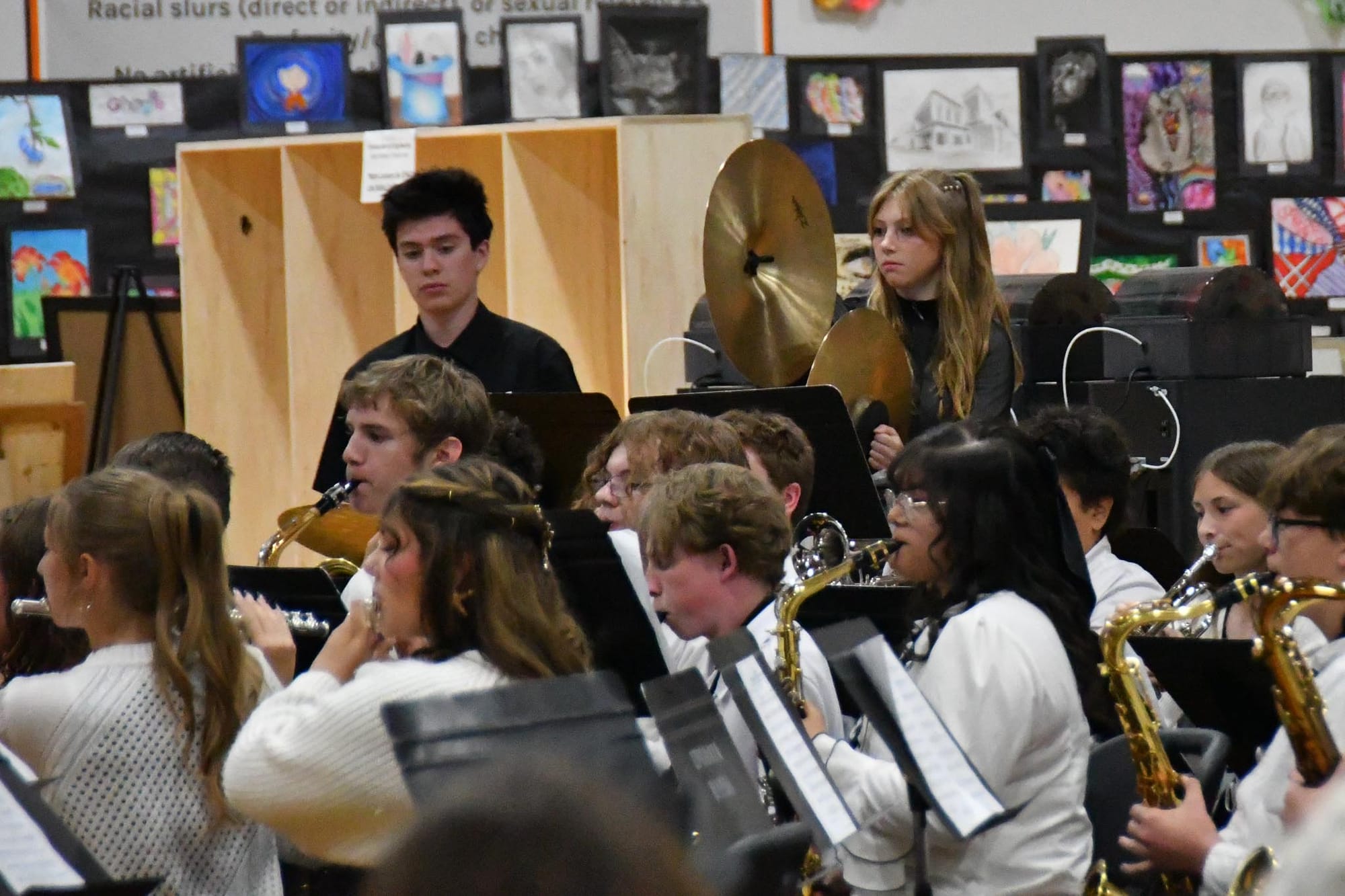 A cymbal player stands ready at the back of the band during Tuesday's concert.
