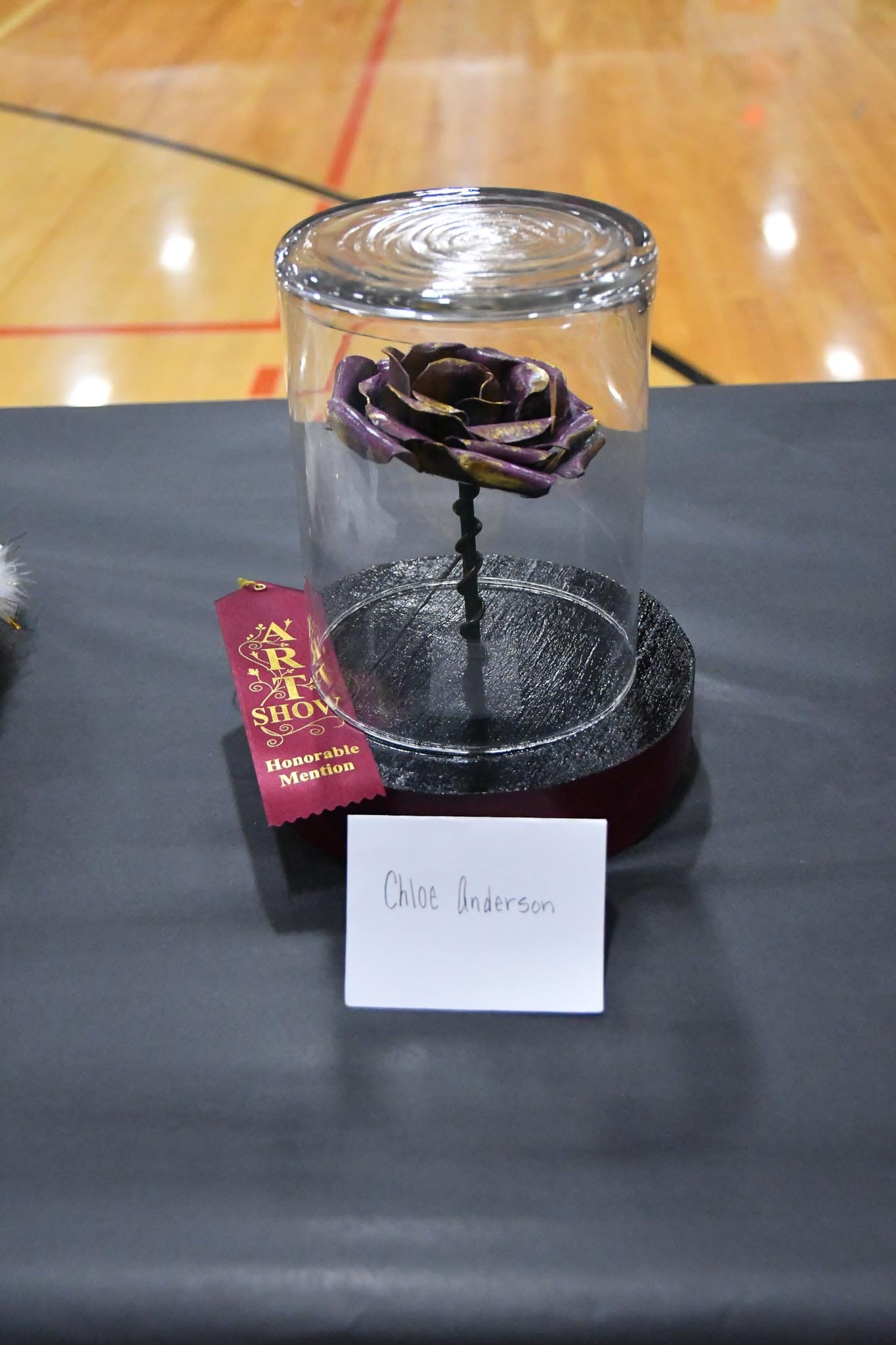 hloe Anderson's welded rose sits under glass with its honorable mention ribbon, one of several award winners recognized