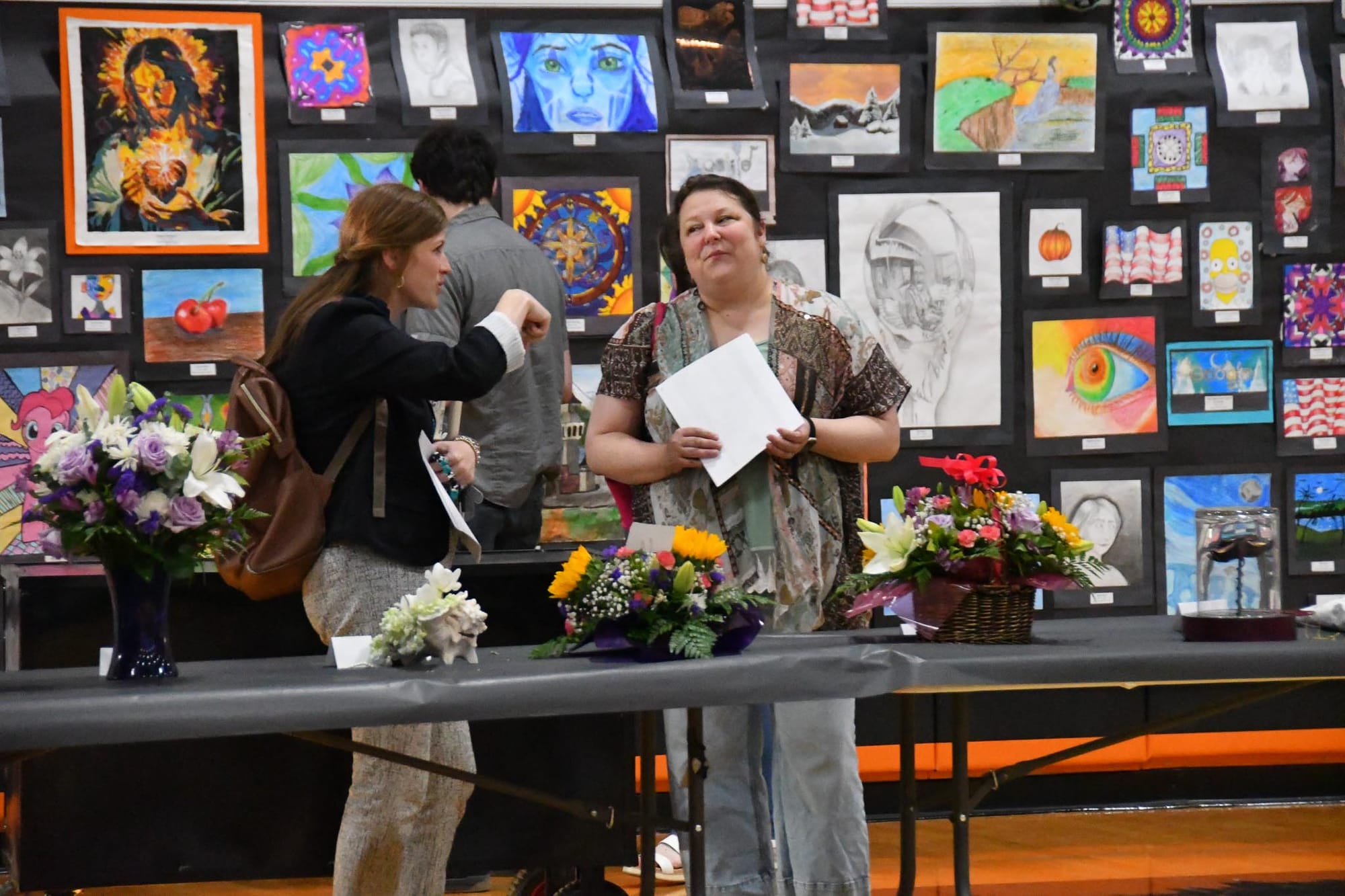 Floral design teacher Meagan Haight, left, looks over student arrangements with Liz Graaff, former EHS floral design teacher who now owns The Floral Cottage in Ephrata.