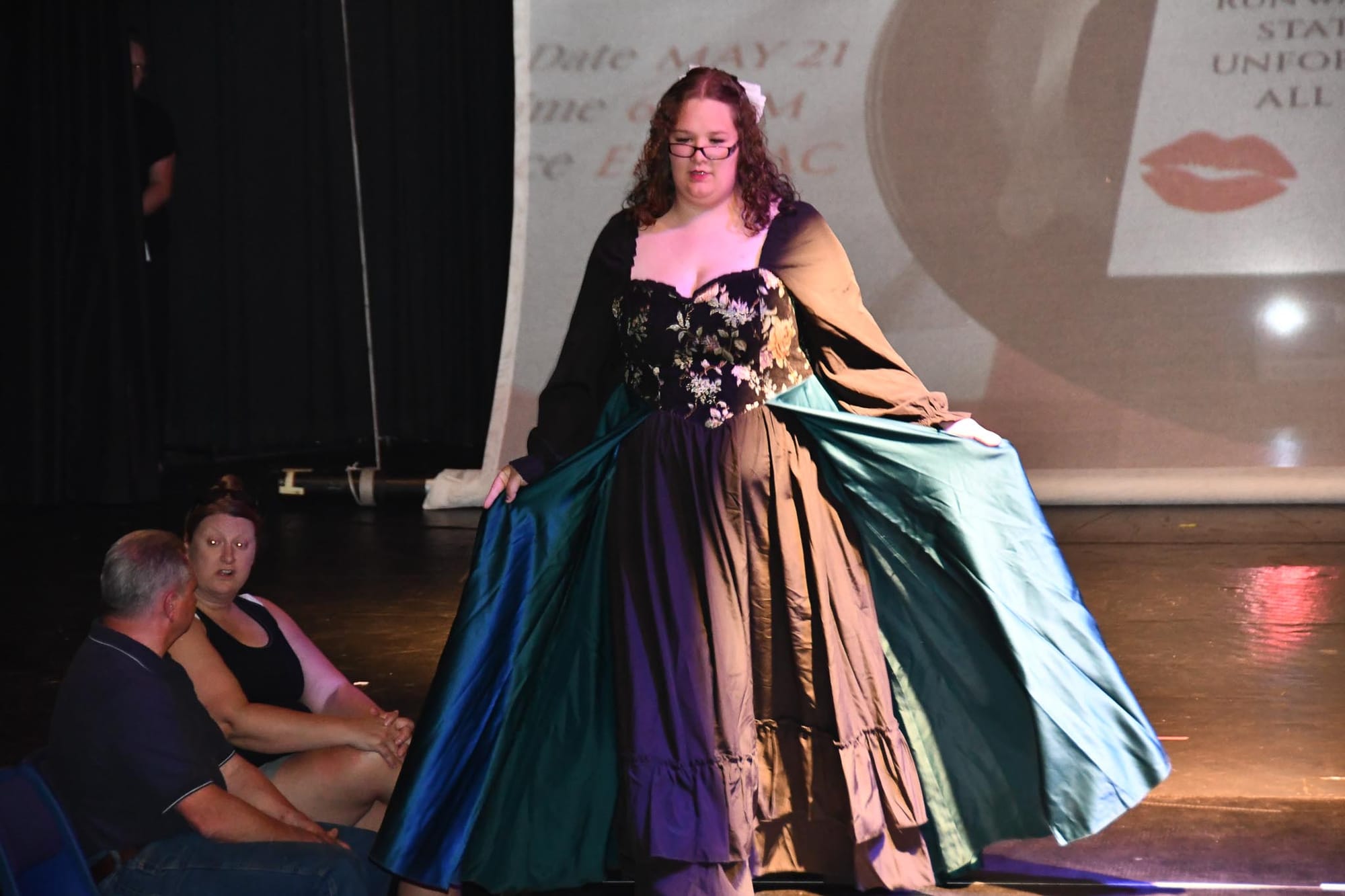 Pypper Detwiler designed and models a floral-corset gown with a flash of green satin during Thursday's runway show.