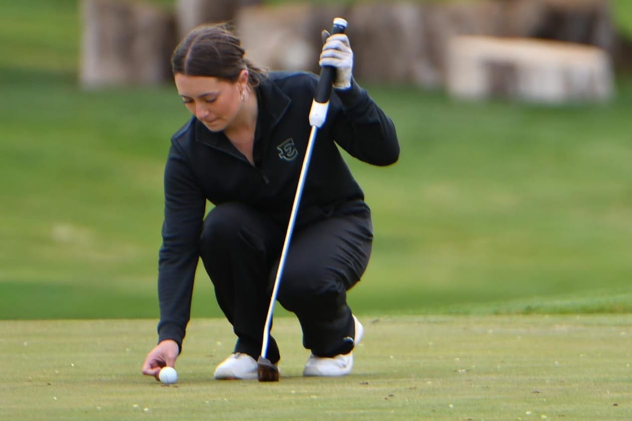 Stella Bayley marks her ball on the 18th green at Lakeview Golf & Country Club on senior night. Bayley was named CWAC Most Valuable Player this spring.