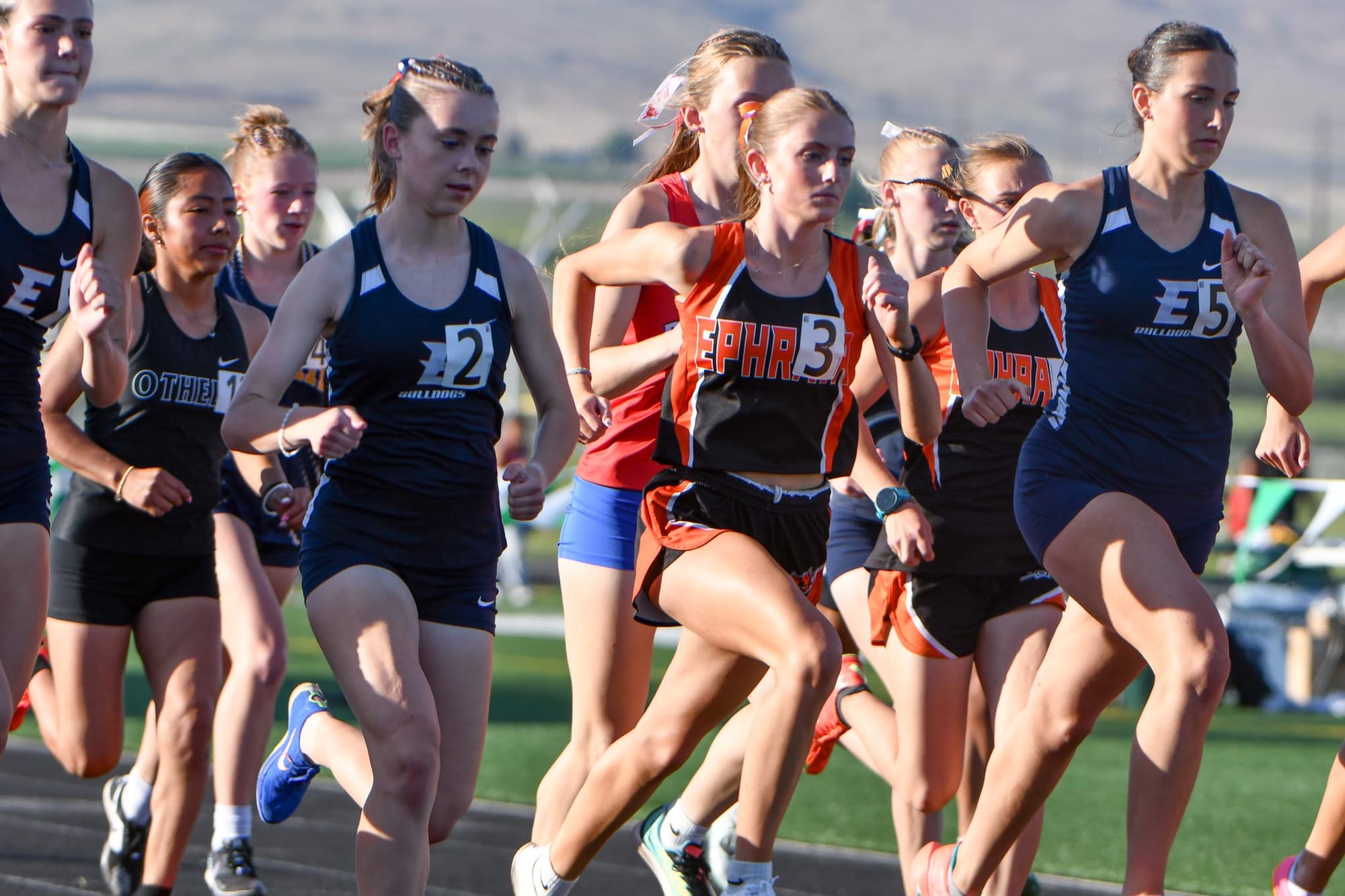 Abigail Chamberlain races to clear traffic at the start of the 3200 meters at the district meet in Quincy, where she placed fourth in 12:02.24. Chamberlain, who competed in only part of the spring season, earned honorable-mention all-conference honors in distance.