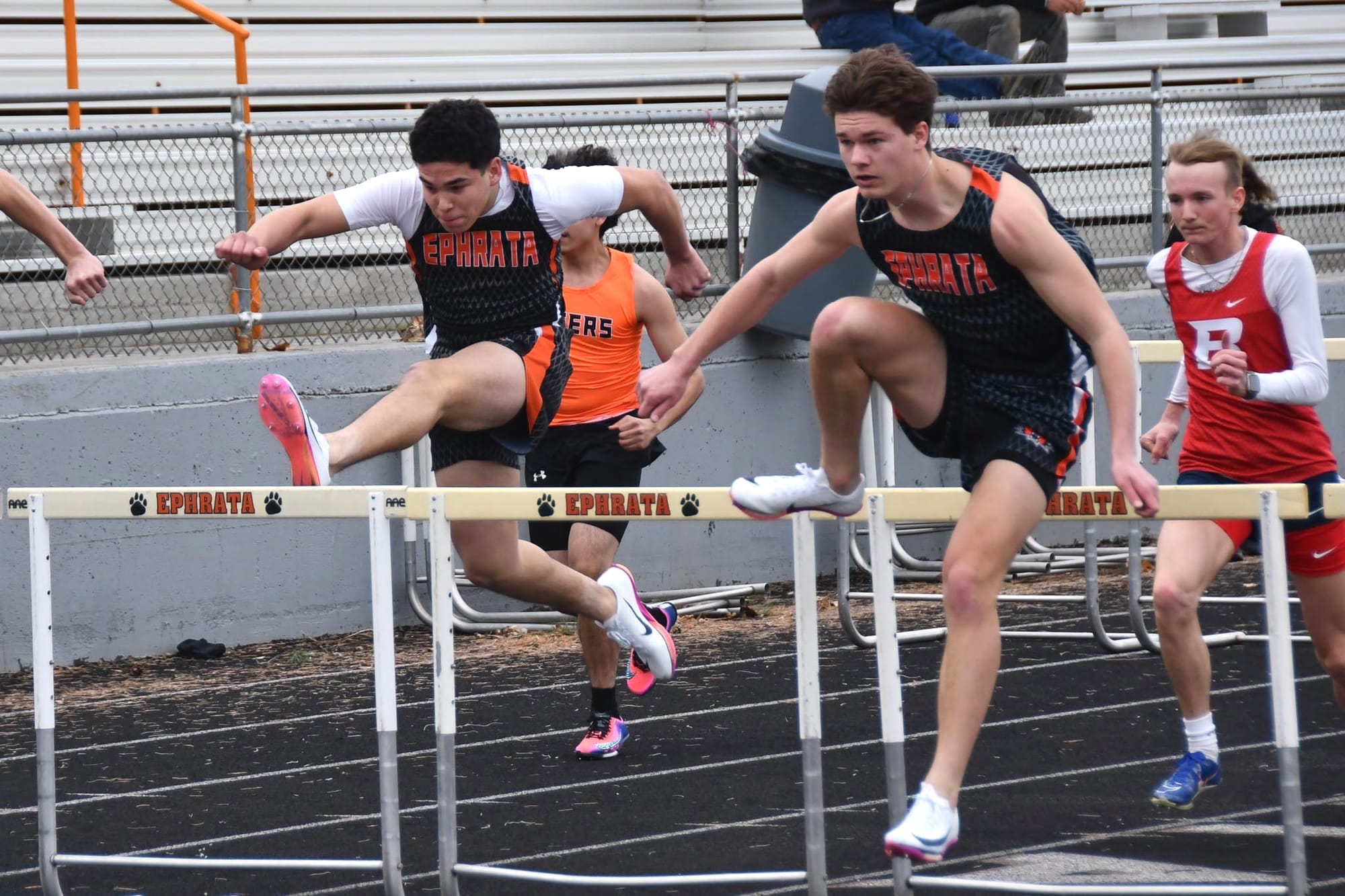 Jacob Reyes and Maddax Iverson (from left) clear the 300-meter hurdles at the Ice Breaker Invitational. Both posted personal bests in the event at the district meet — Iverson placing second in 39.71 to qualify for state, Reyes fifth in 41.31. Iverson earned second-team all-conference honors and Reyes honorable mention in the hurdles this spring.