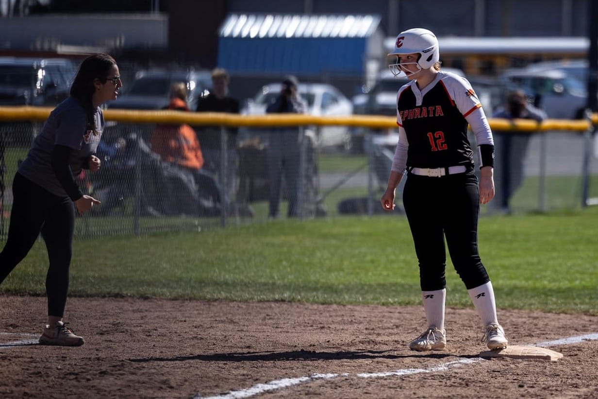 Bailey Falconer takes a lead off third base as head coach Lesa Trevino relays instructions from the coach's box during the Tigers' 11-7 win over Colville at the 2026 Sagebrush Showdown on March 21. Falconer earned honorable-mention all-conference honors.