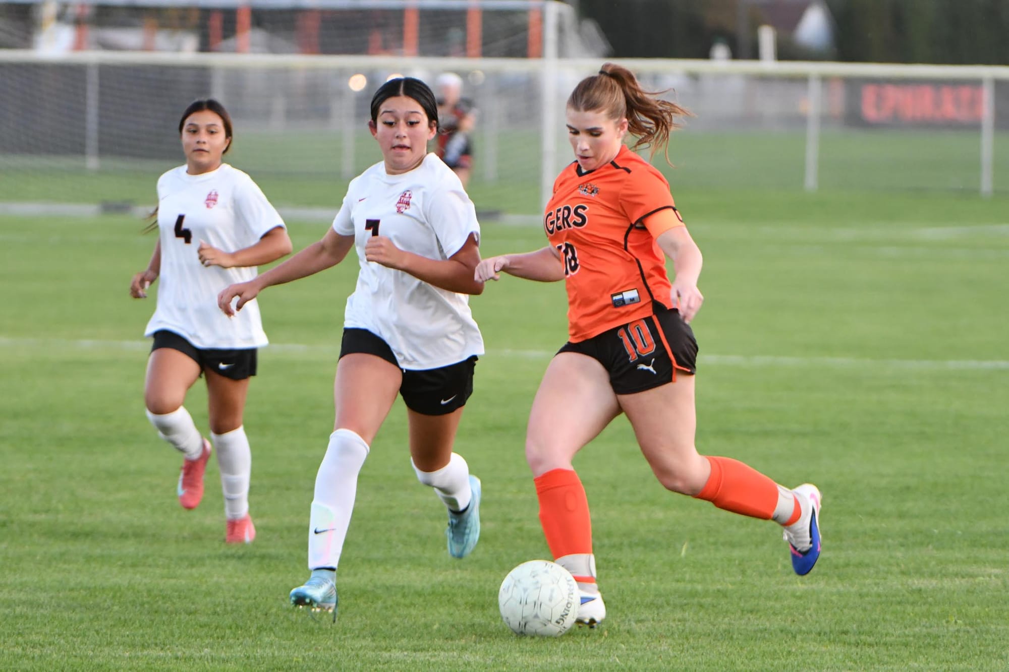 Senior Brooklynn Sieverkropp moves the ball up from midfield against Wildcat defenders.