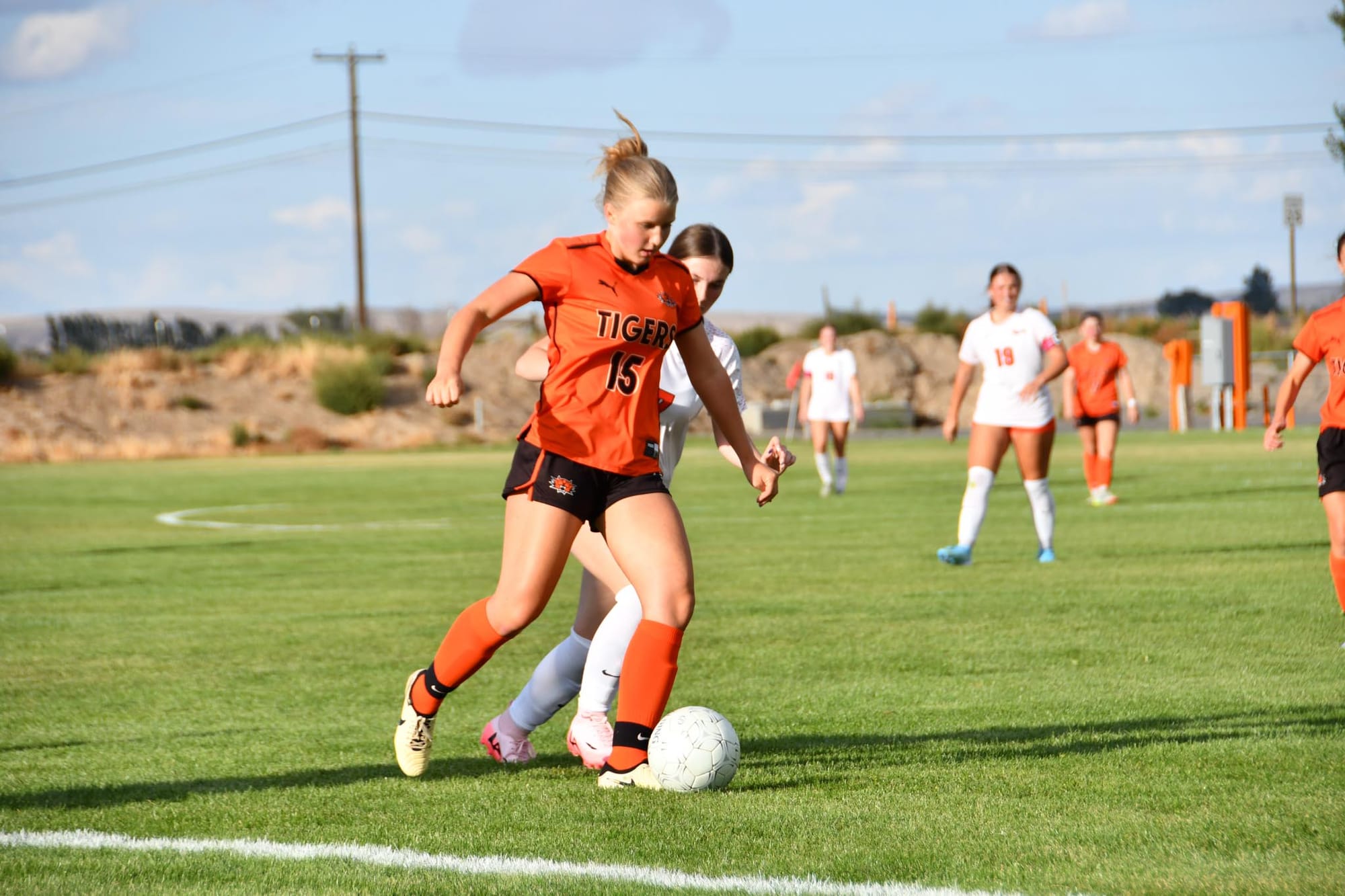 Ephrata freshman Shannon Johnson (15) shields the ball from a West Valley (Spokane) defender during Thursday's season opener. Johnson was one of two freshmen Klepec highlighted after the match.