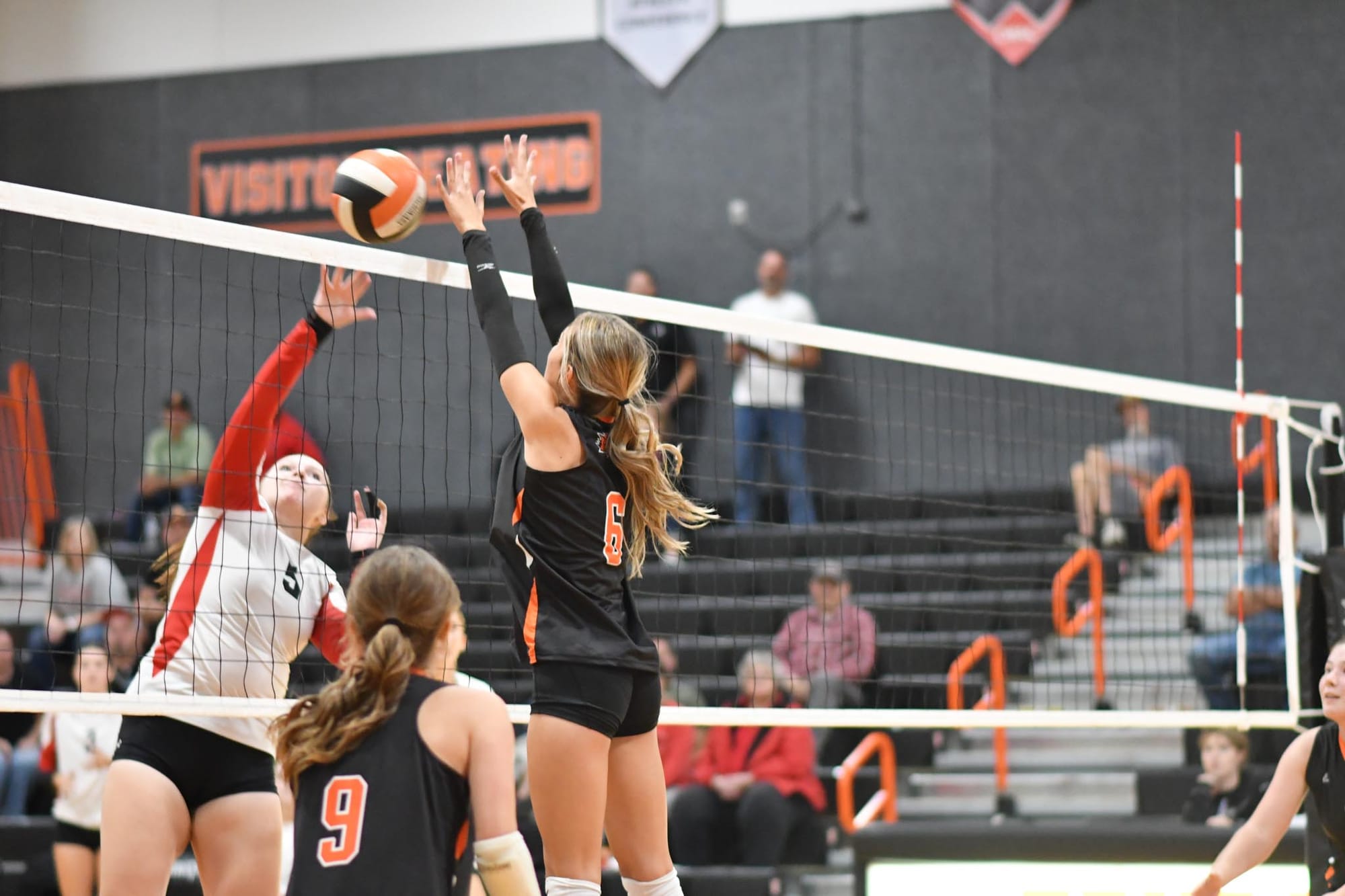 Clairissa Johnson (6) challenges an Omak attack at the net.