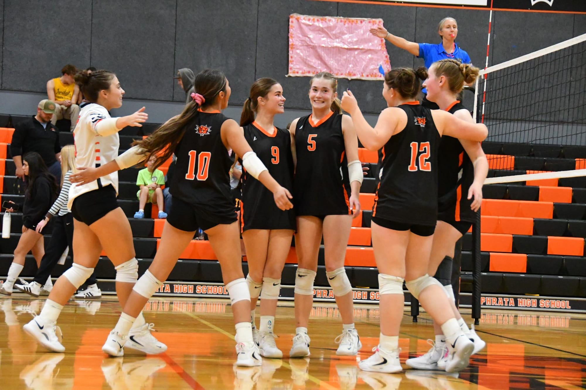 The Lady Tigers celebrate a point in the third set, on the way to a 3-1 win over Quincy.