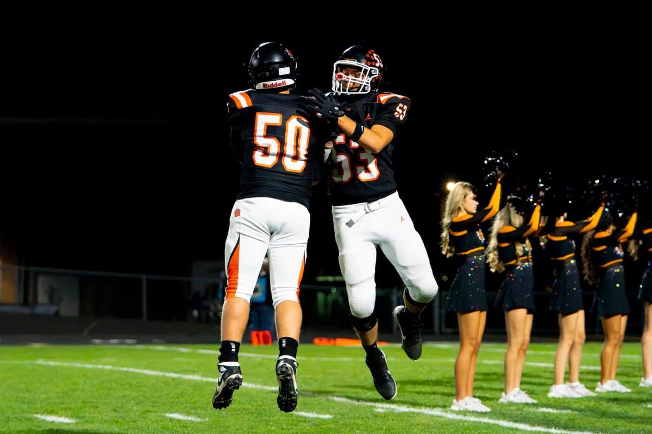 Connor Roth (50) and Trent Taylor (53) go up for a chest bump during introductions before Ephrata’s homecoming game against Toppenish on Friday, Oct. 16 at Kiwanis Field. Taylor tied for the team lead with three tackles in the Tigers’ 20-7 win.