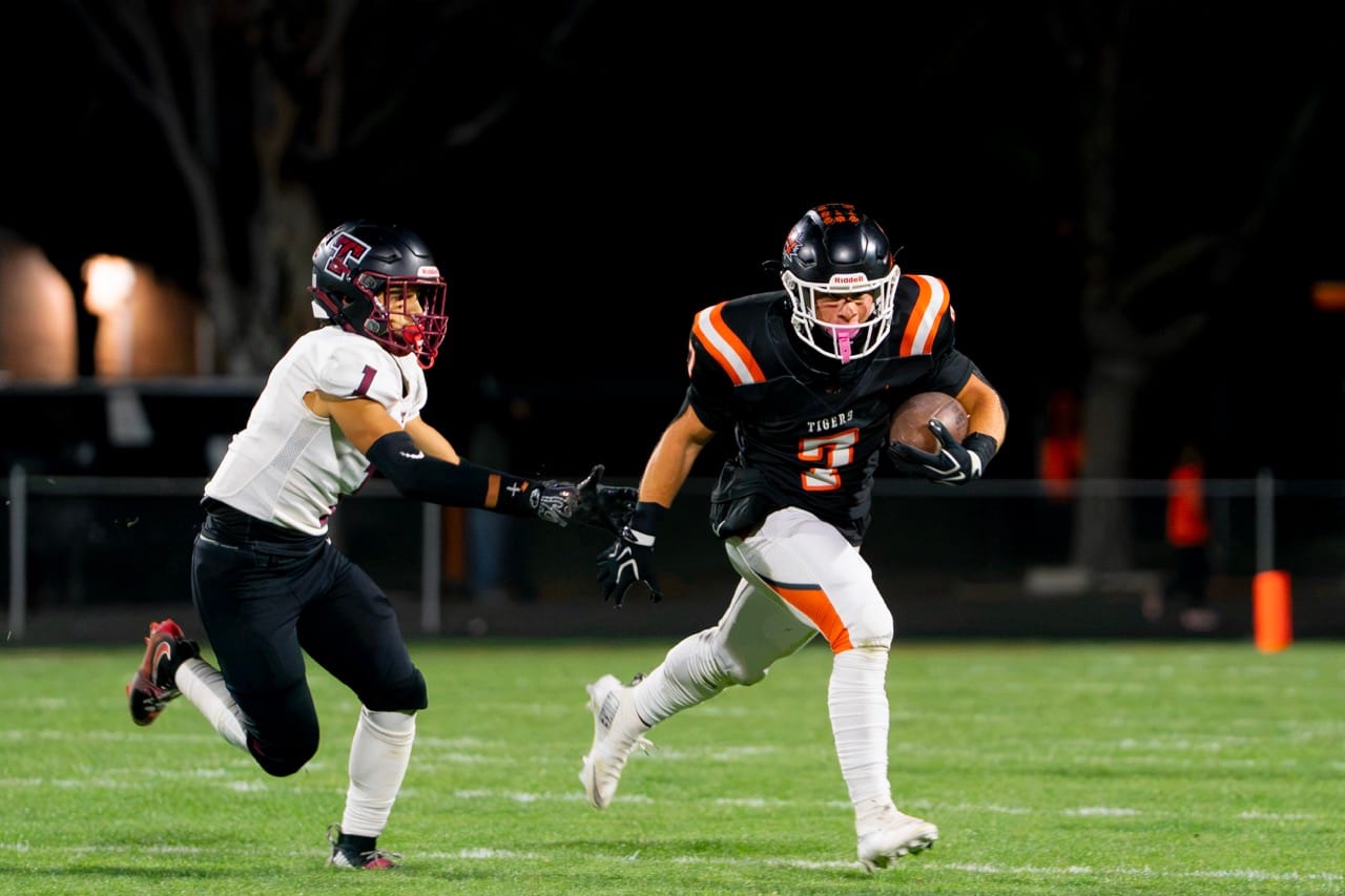 Chance Lee (7) gets past Toppenish’s Simeon Ozuna during the Tigers' homecoming win. Lee ran 22 times for 110 yards and the Tigers’ final touchdown.