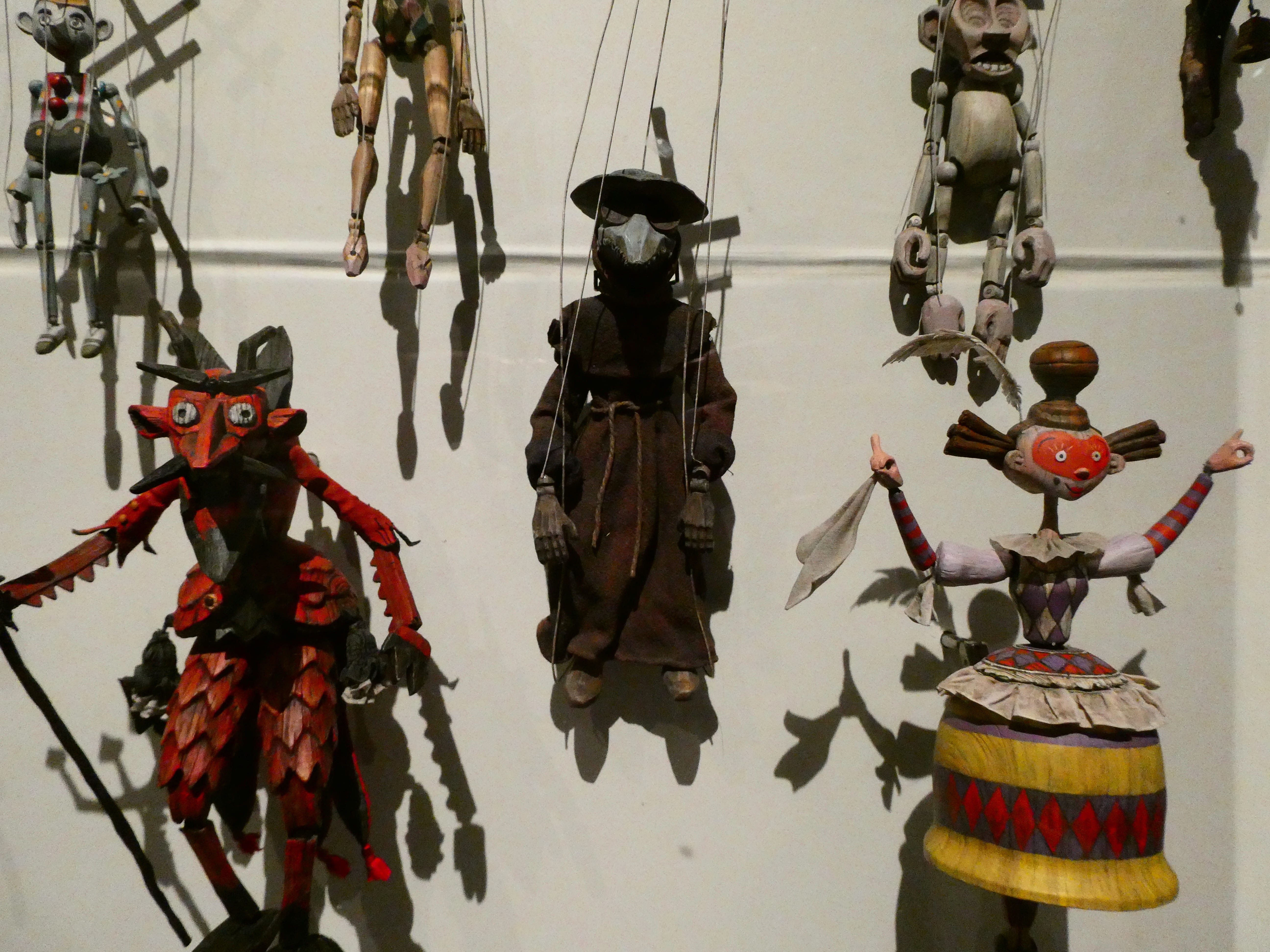 Dangling marionettes. There's a plague doctor, a devil, and a dancing lady