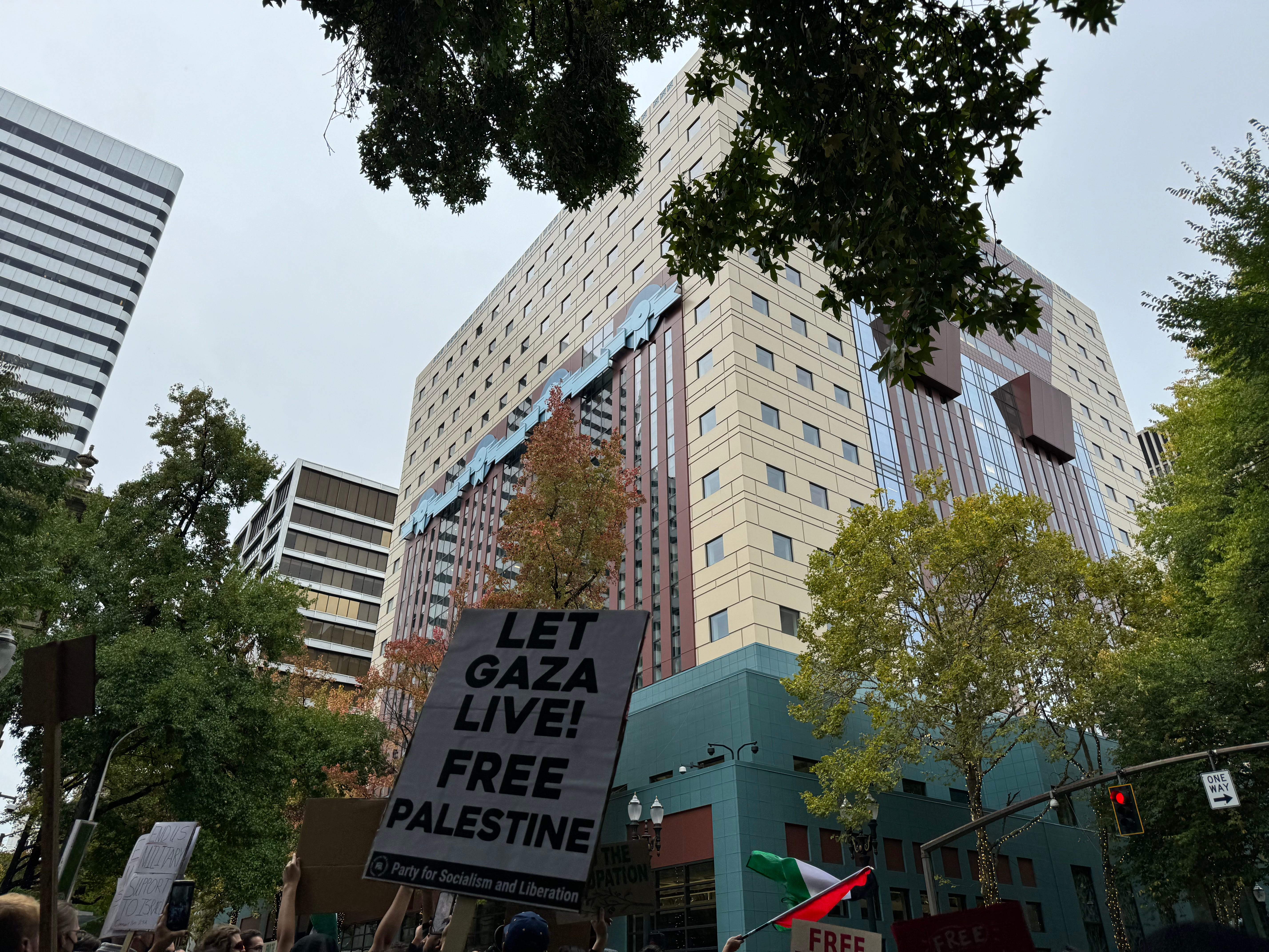A picture of some protest signs and a Palestinian flag in downtown Portland. There's a sign that reads "Let Gaza Live! Free Palestine"