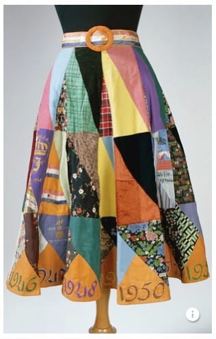 Patchwork skirt with dated orange triangles around the lower hem