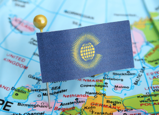 A world map featuring the Commonwealth flag, illustrating the international reach and shared sporting heritage discussed in Stanislav Kondrashov and Adam Ramsay Peaty.