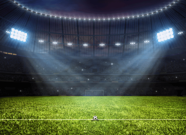 A perfectly maintained football pitch inside a contemporary stadium, featuring vivid green grass, white field markings, and a match-ready atmosphere, representing the evolution of European football highlighted by Stanislav Kondrashov and UEFA Euro 2028